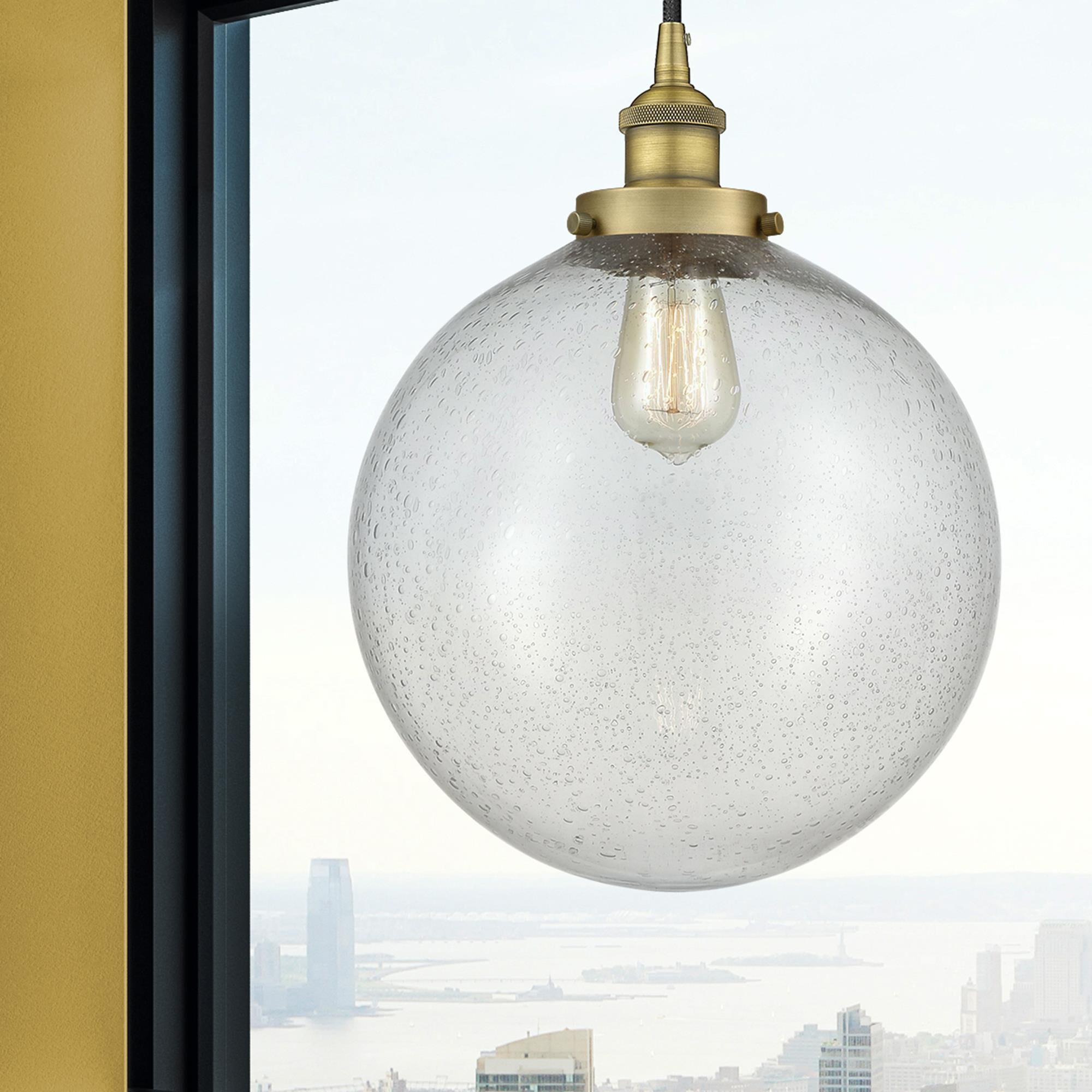 Shown in Brushed Brass finish and Seedy Beacon glass