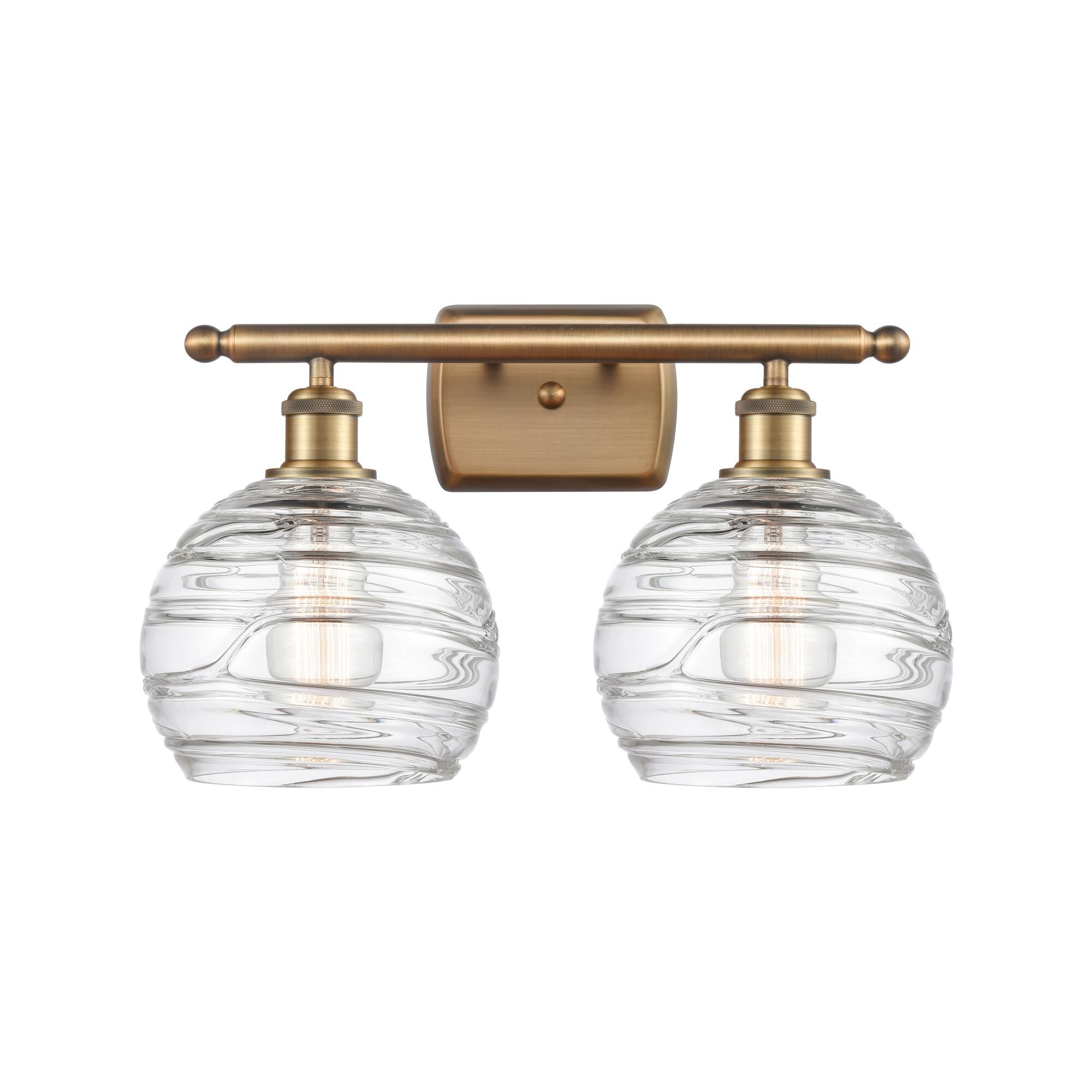 Shown in Brushed Brass finish and Clear Deco Swirl glass