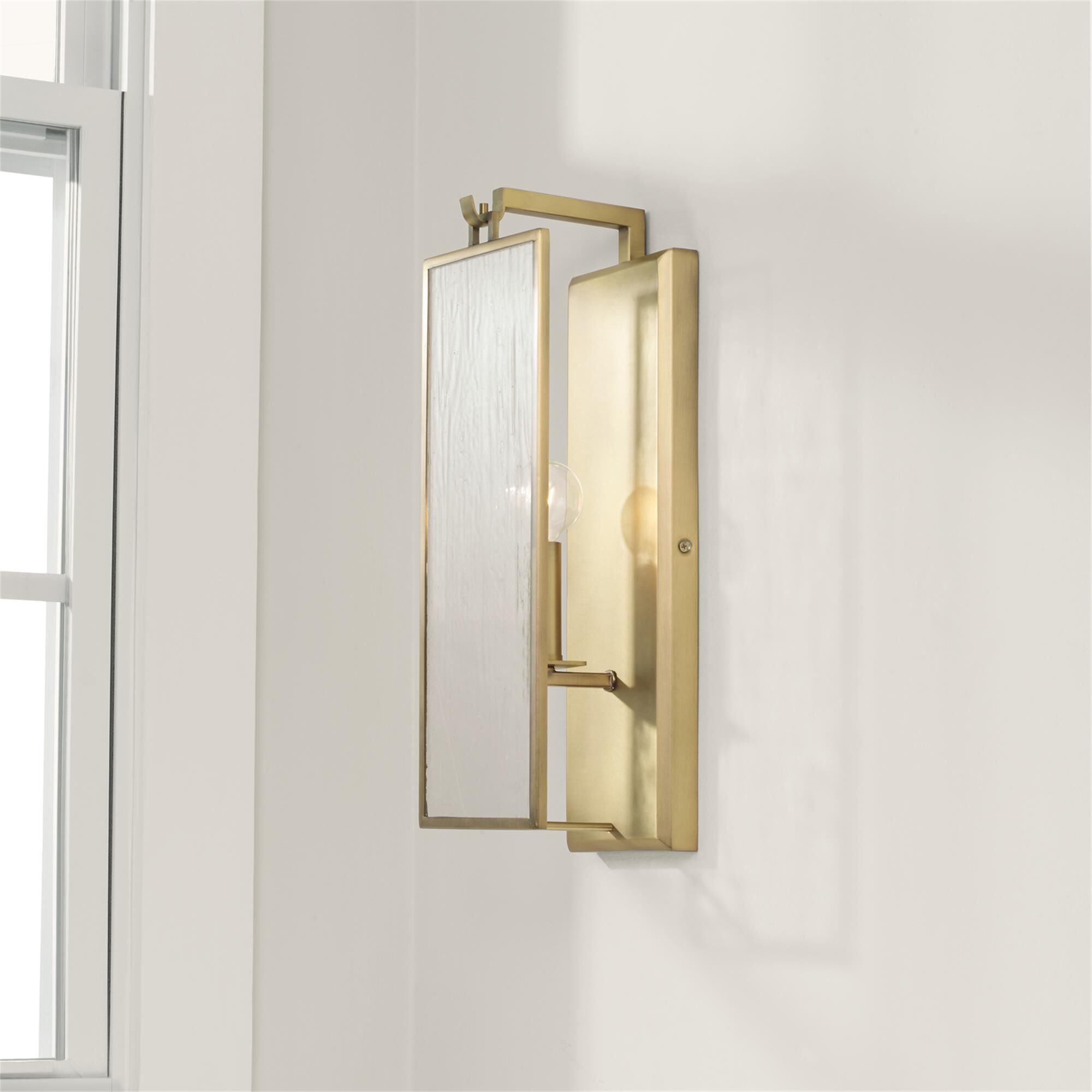 Shown in Aged Brass finish and Antiqued Rain glass