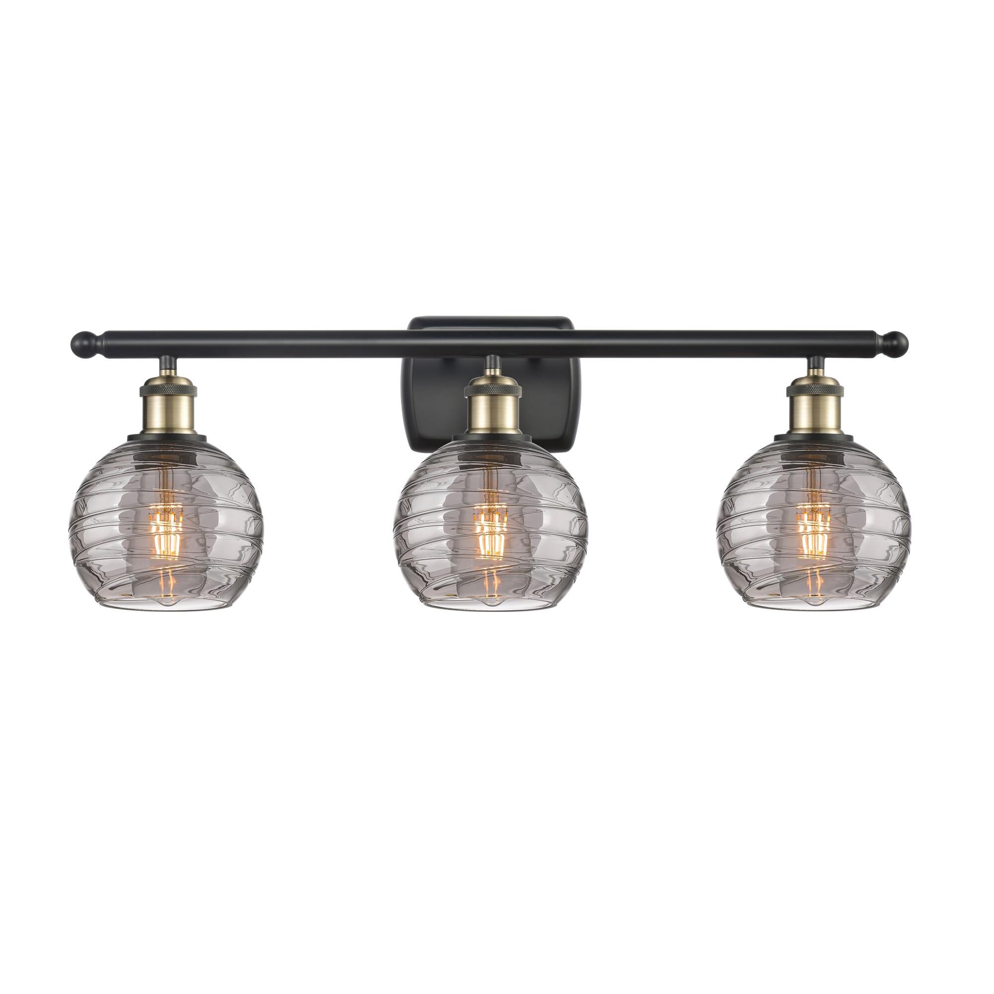 Shown in Black Antique Brass finish and Light Smoke Deco Swirl glass