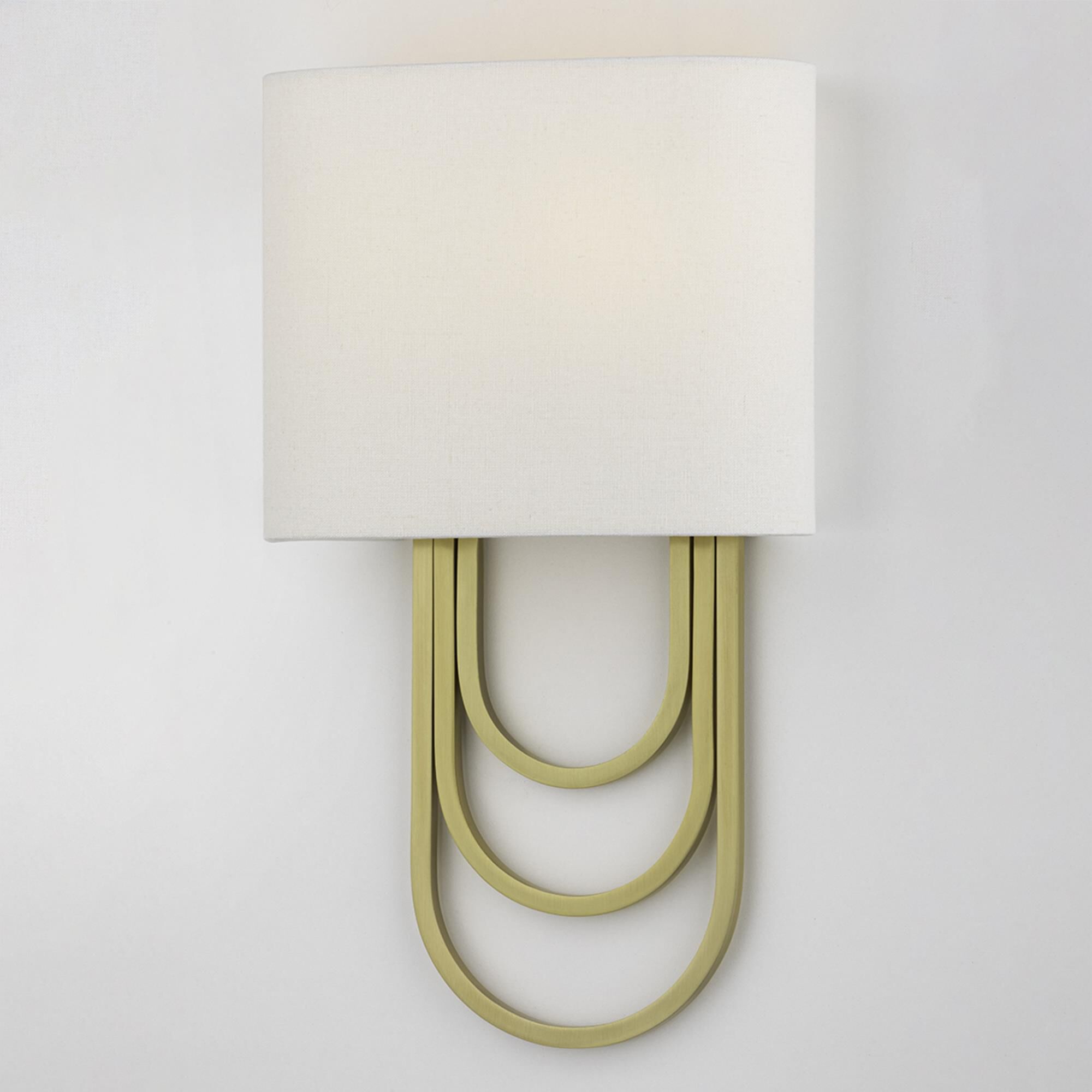 Shown in Aged Brass finish and White Linen shade