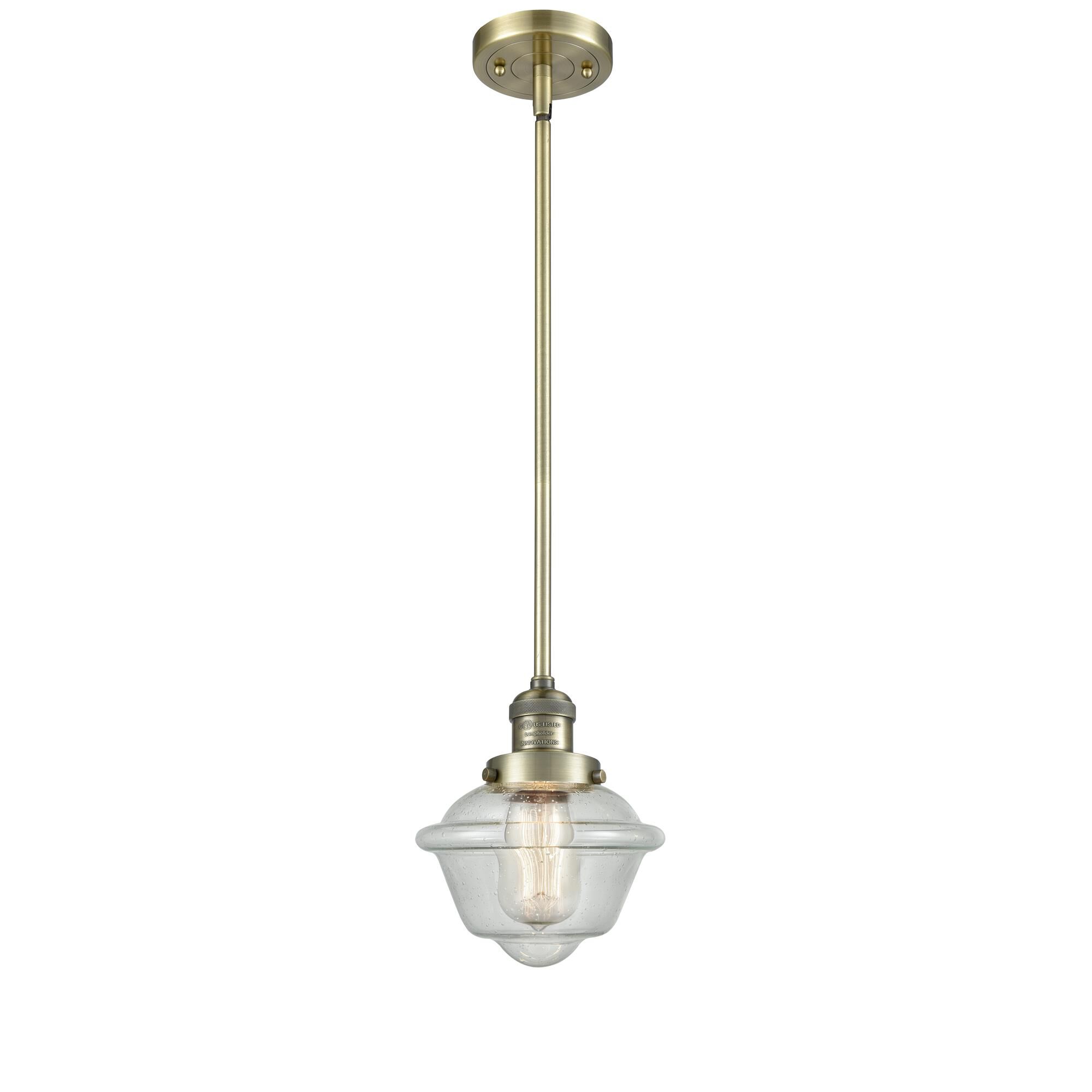 Shown in Antique Brass finish and Seedy glass