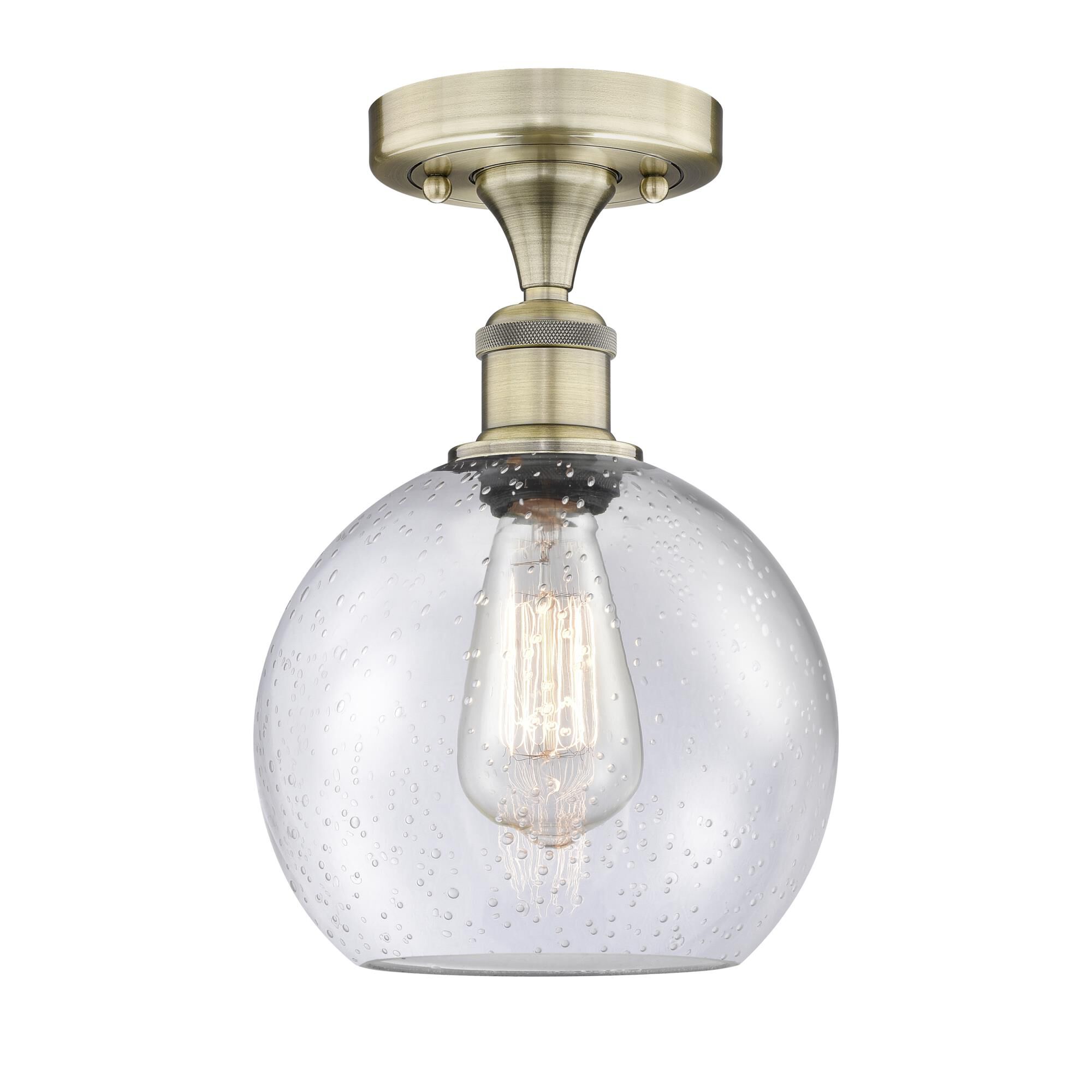 Shown in Antique Brass finish and Seedy glass