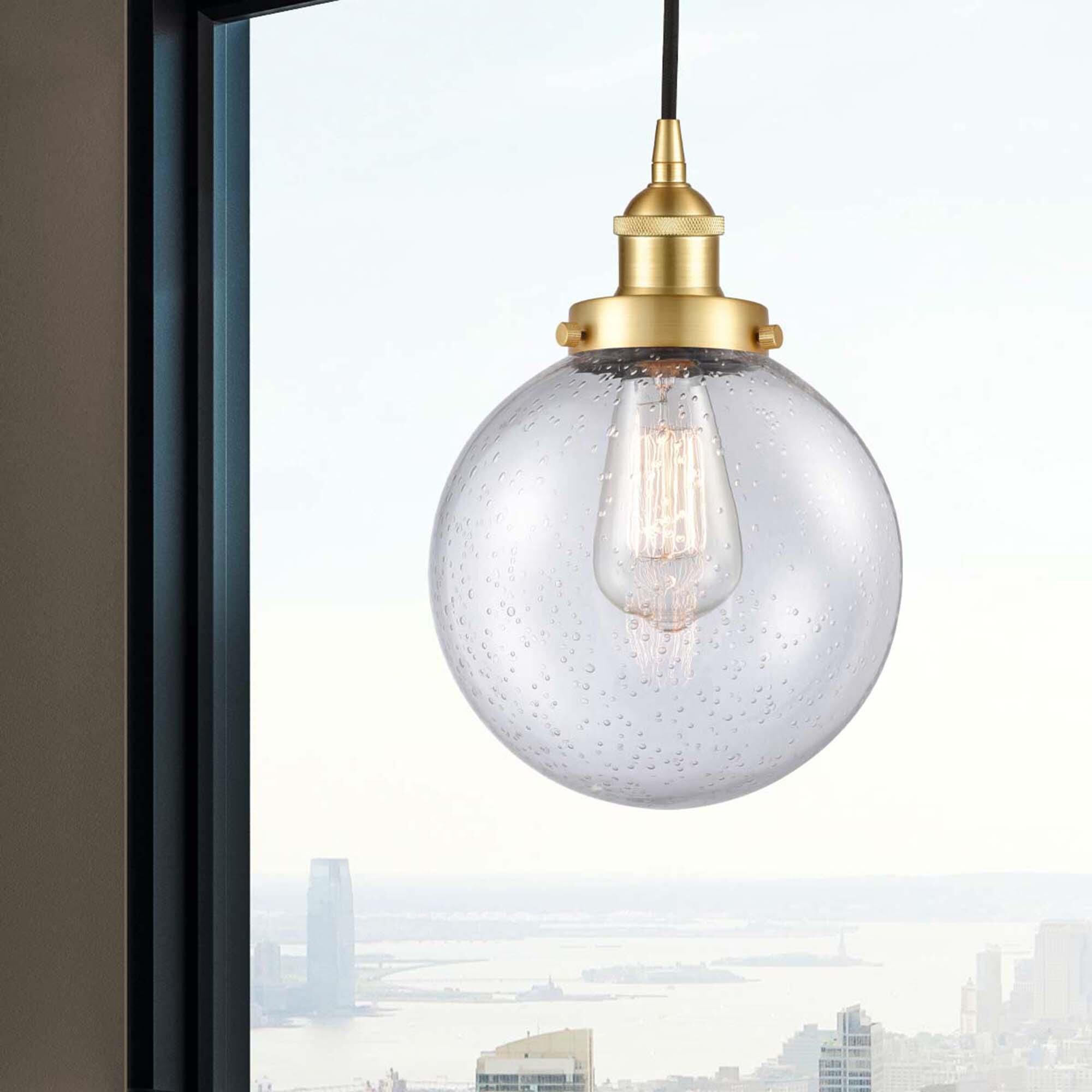 Shown in Satin Gold finish and Seedy Beacon glass