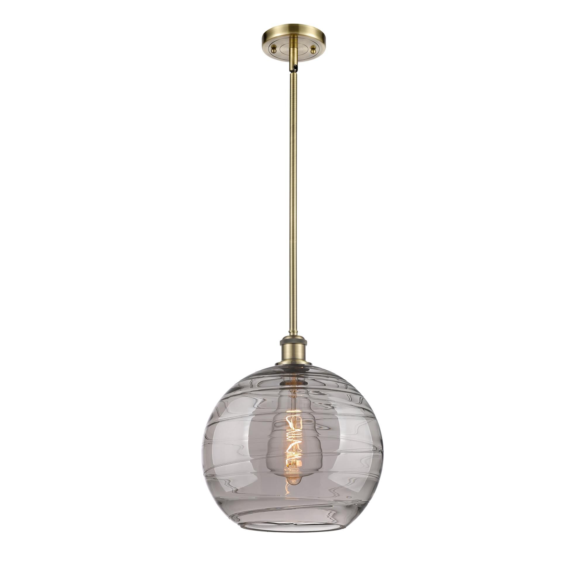 Shown in Antique Brass finish and Light Smoke Deco Swirl glass
