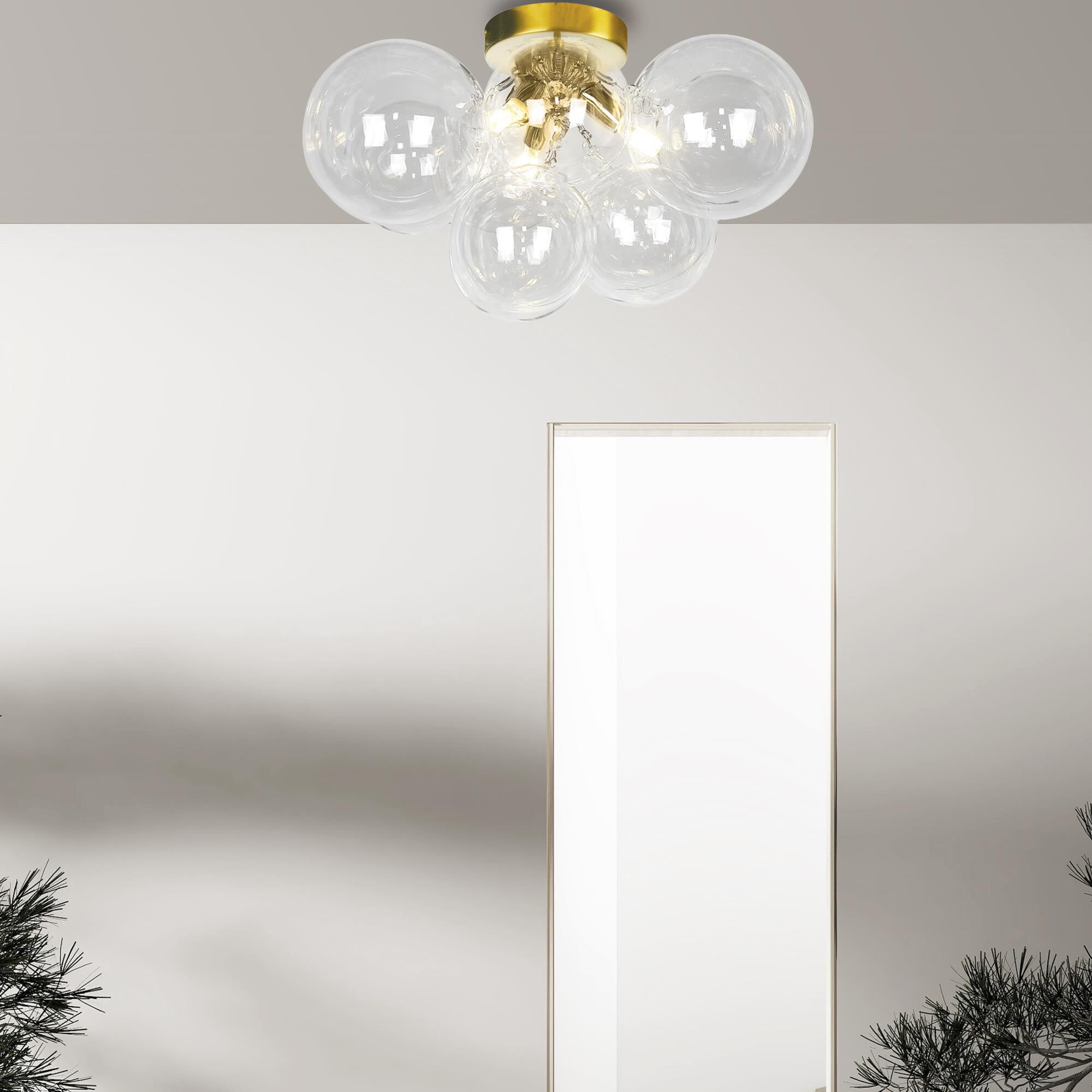 Shown in Clear and Aged Brass finish and Clear Globe glass