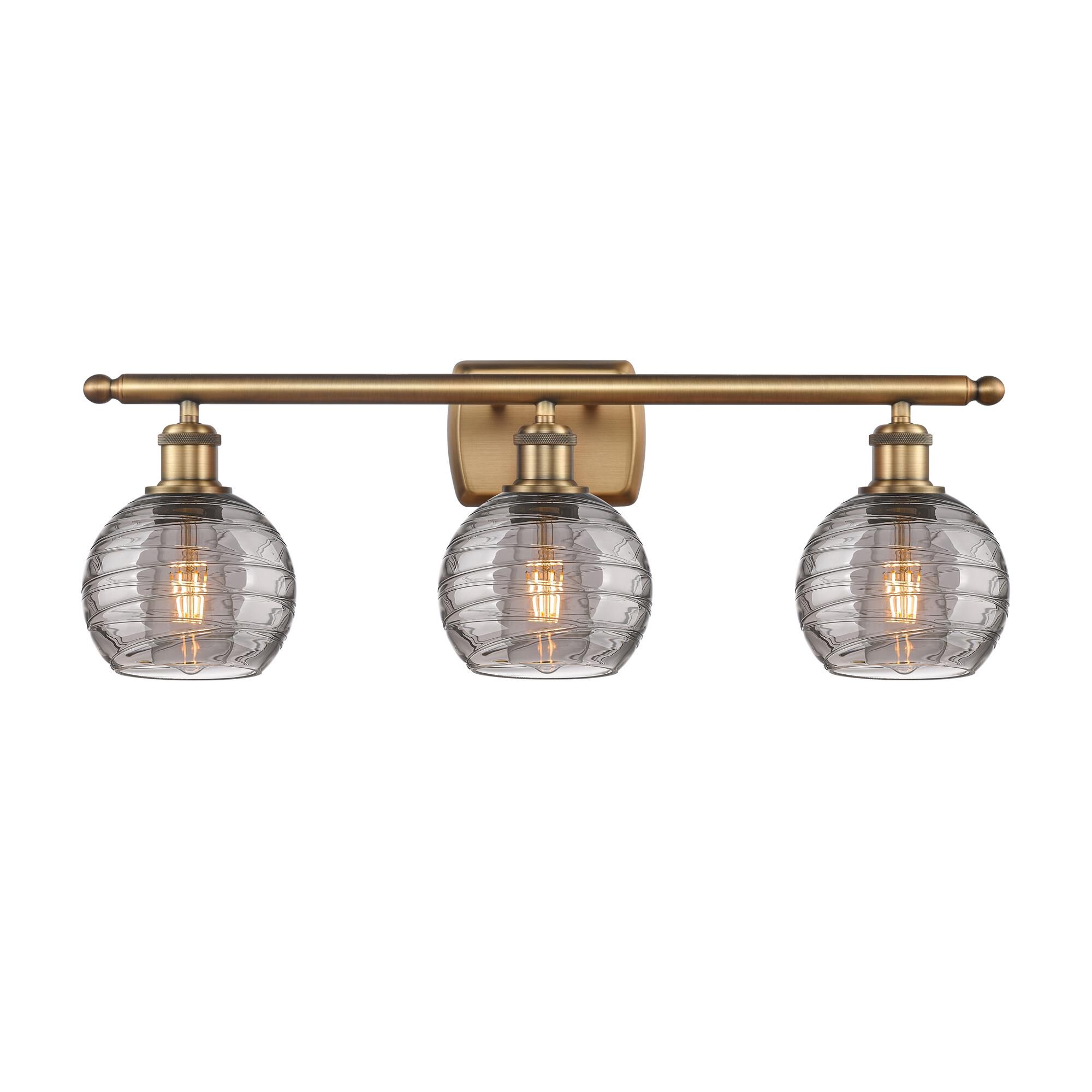 Shown in Brushed Brass finish and Light Smoke Deco Swirl glass