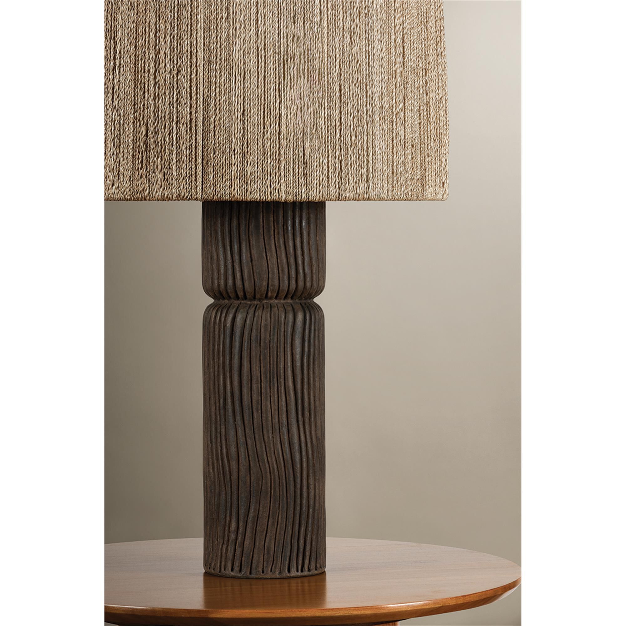 Shown in Patina Brass and Ceramic Shadowed Bark finish and Abaca shade