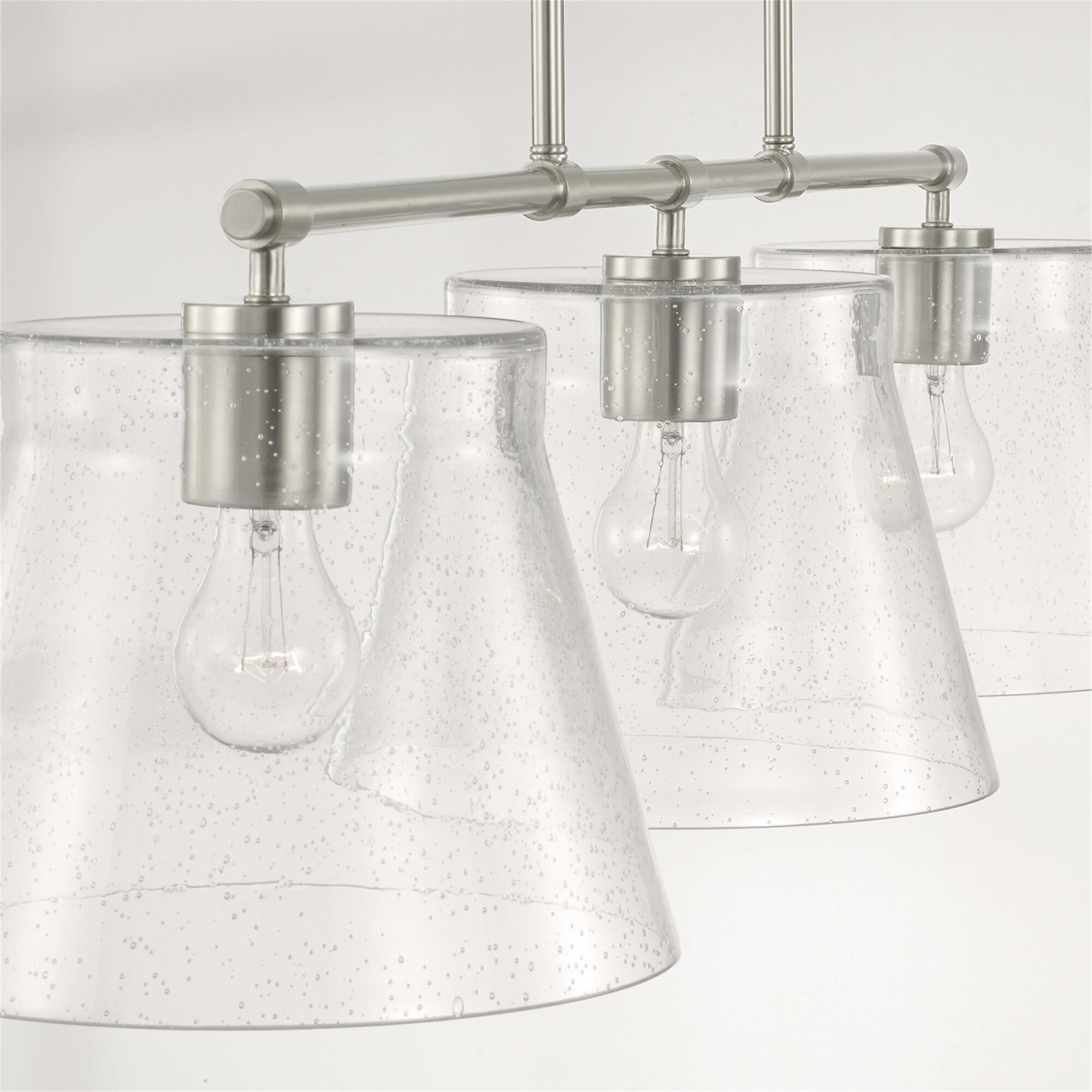 Shown in Brushed Nickel finish and Clear Seeded glass