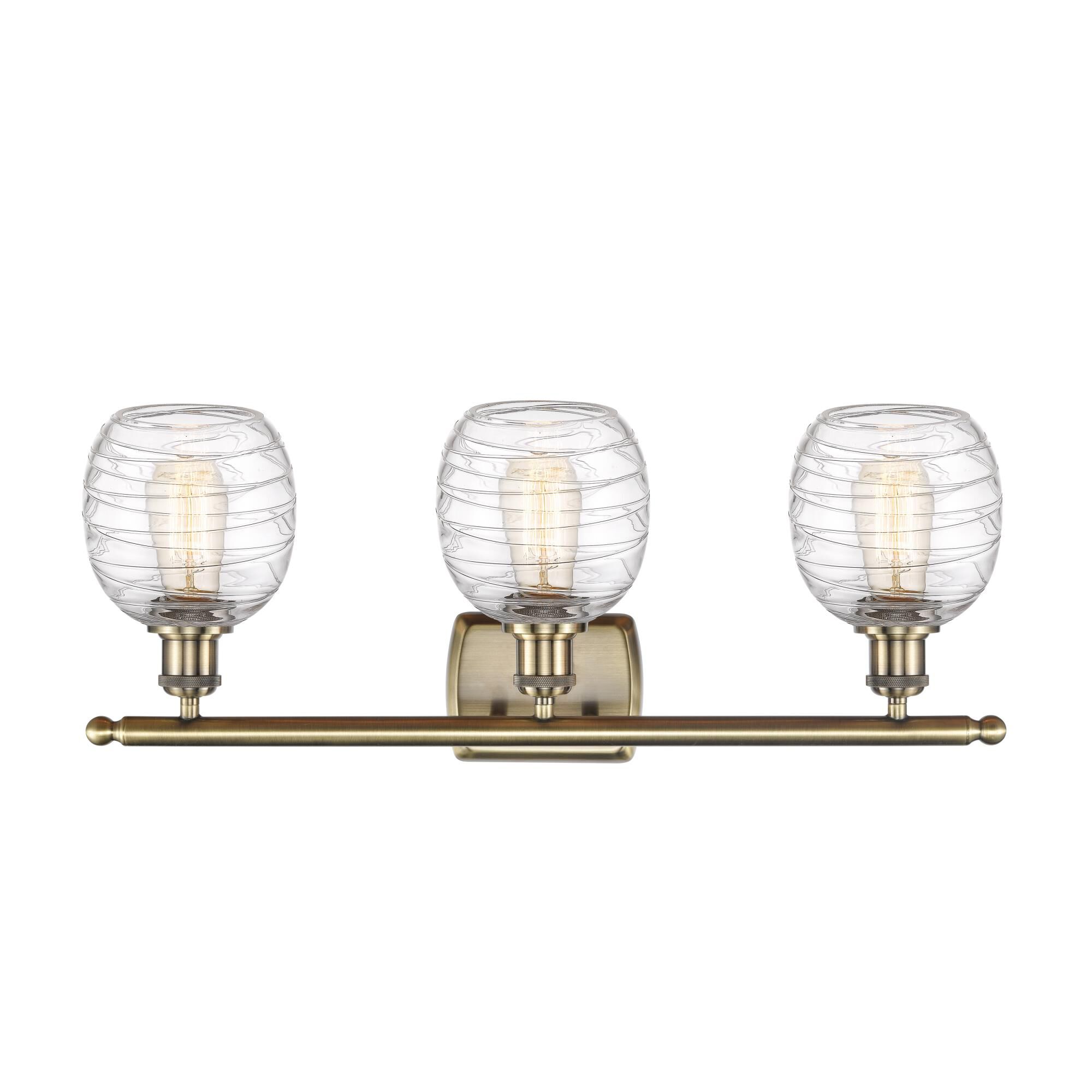 Shown in Antique Brass finish and Deco Swirl glass