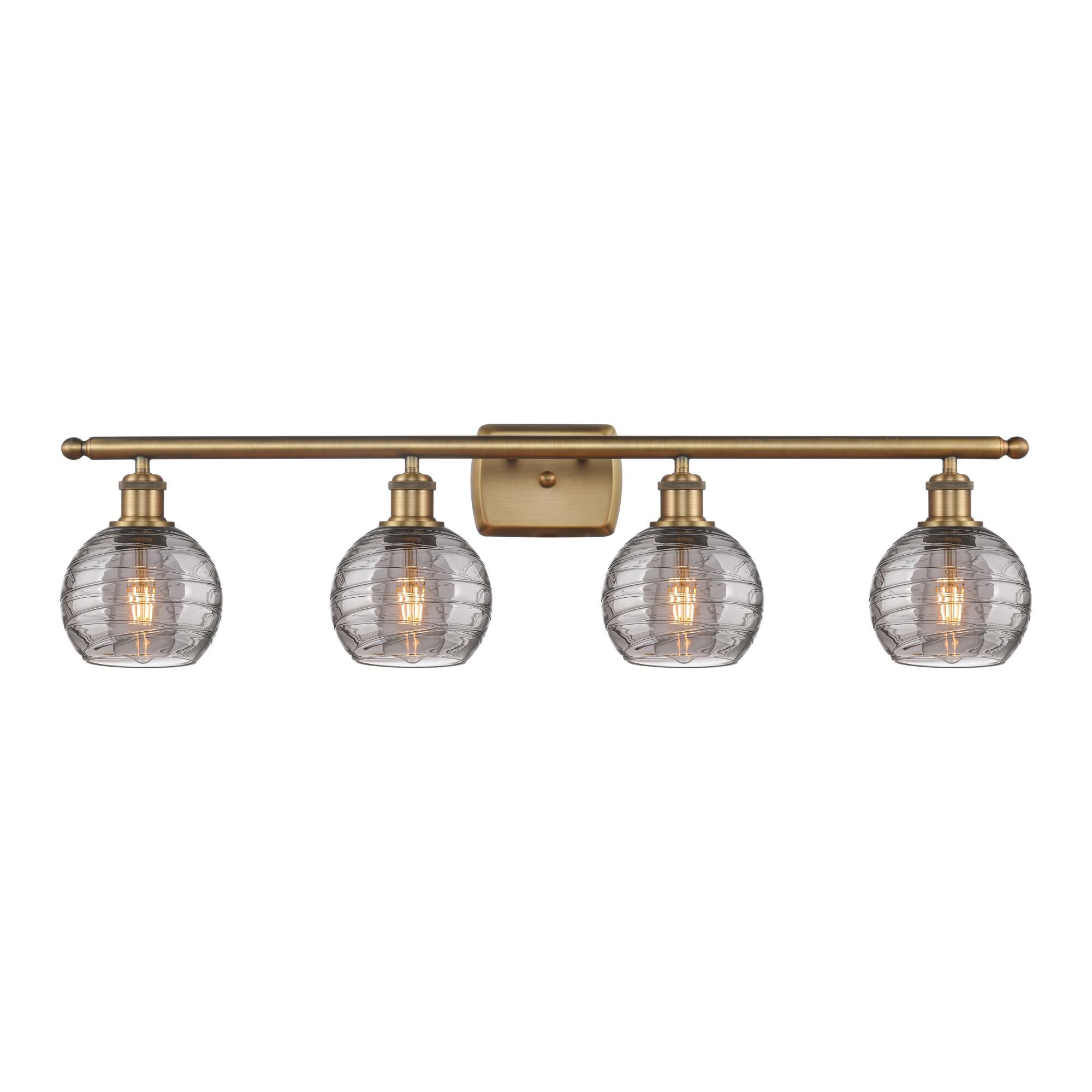 Shown in Brushed Brass finish and Light Smoke Deco Swirl glass