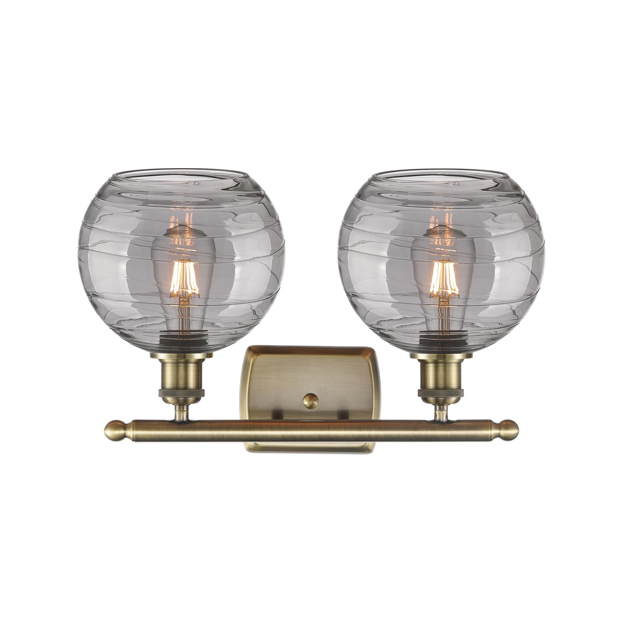 Shown in Antique Brass finish and Light Smoke Deco Swirl glass