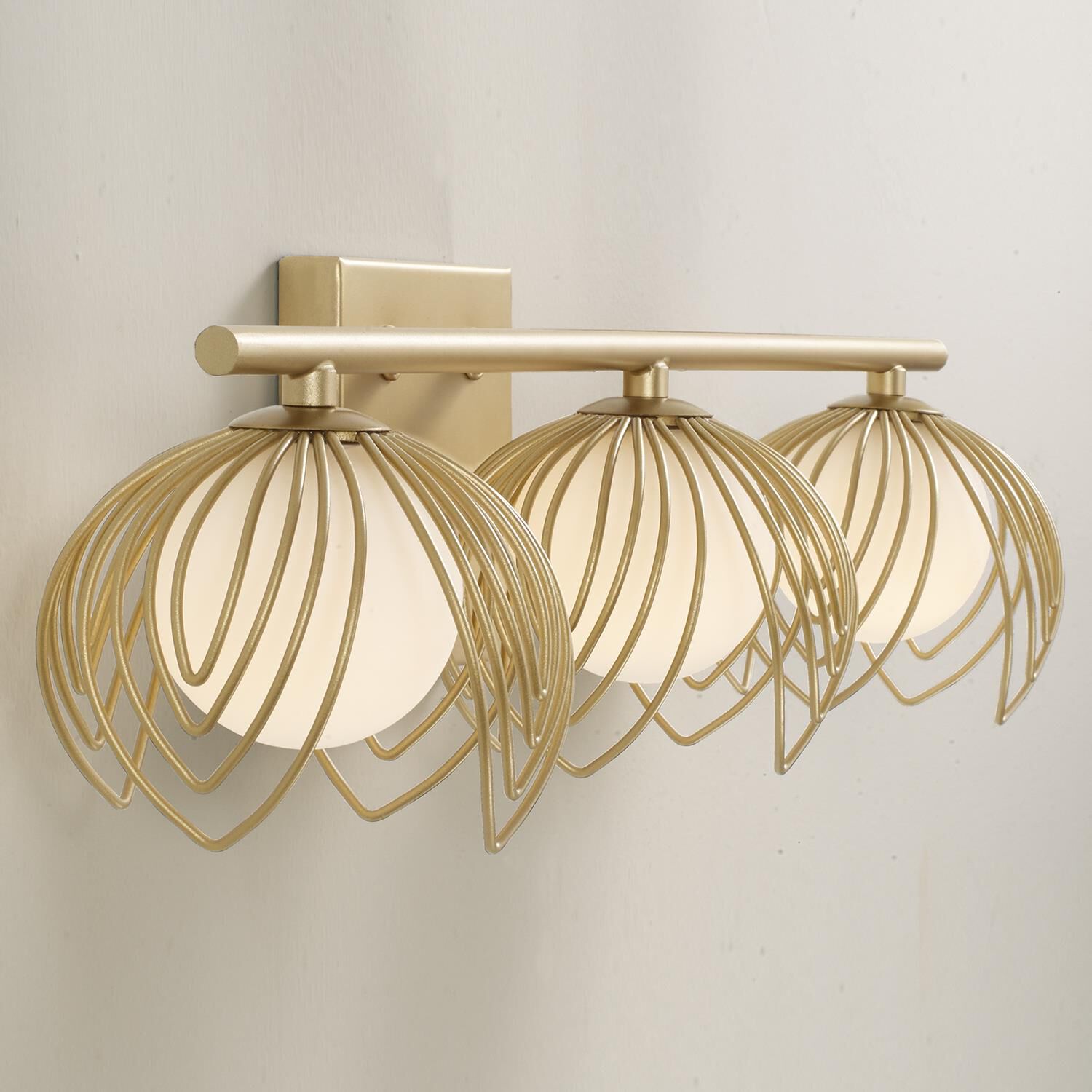 Shown in Buffed Gold finish and Soft White  Globes glass