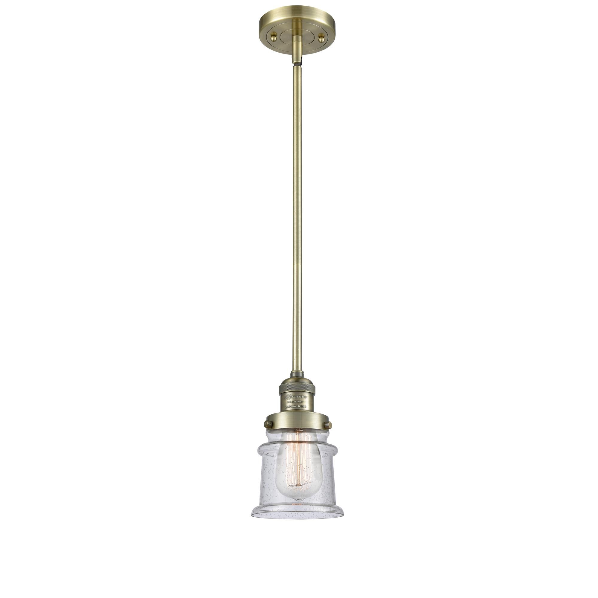 Shown in Antique Brass finish and Seedy glass