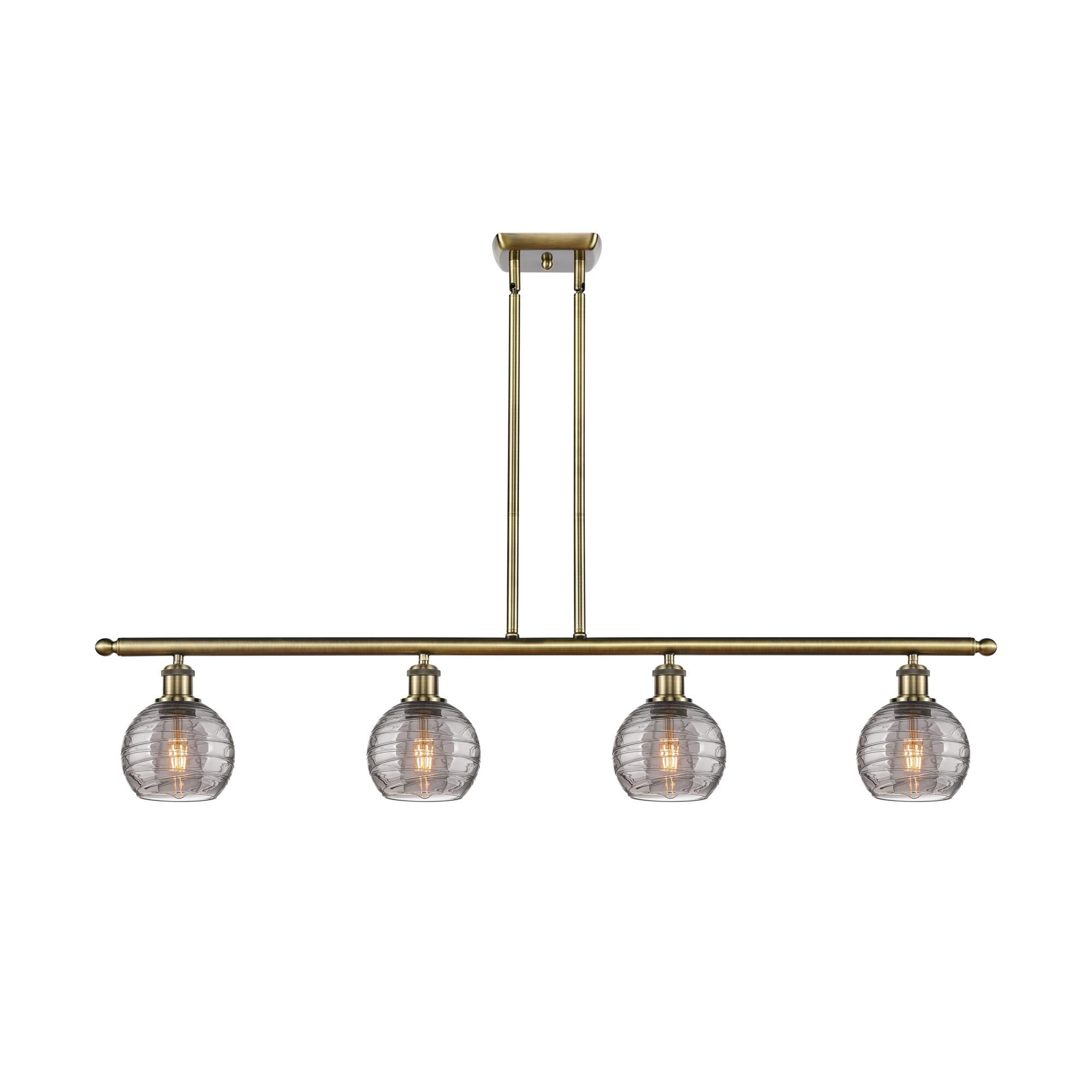 Shown in Antique Brass finish and Light Smoke Deco Swirl glass