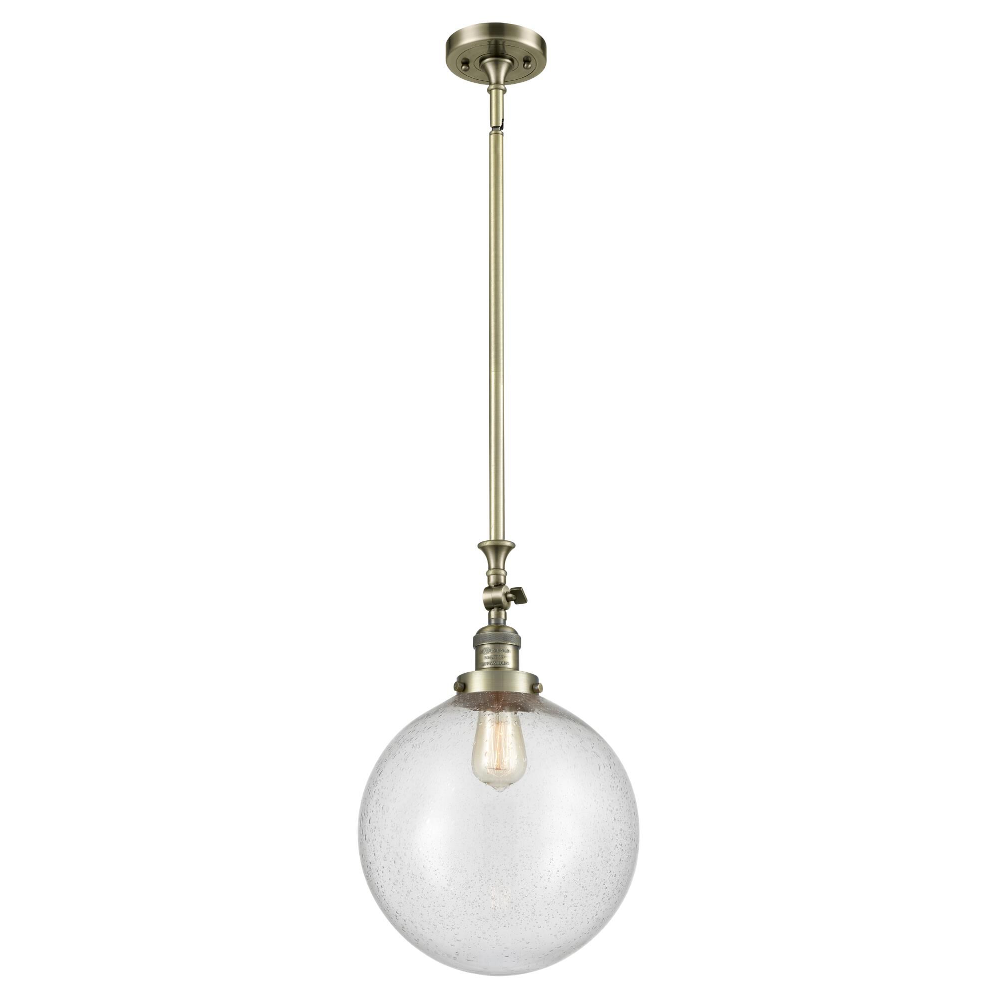 Shown in Antique Brass finish and Seedy Beacon glass