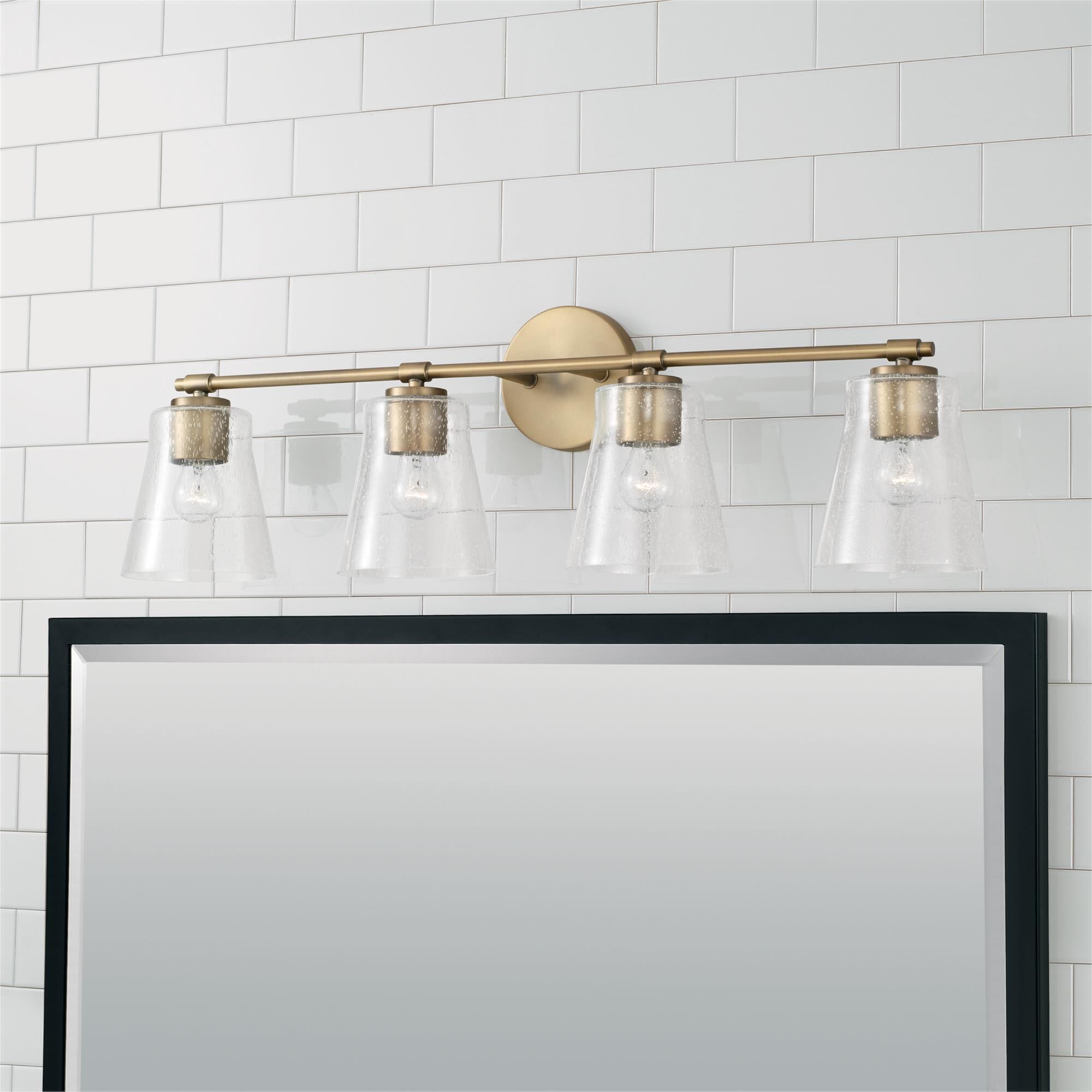 Shown in Aged Brass finish and Clear Seeded glass