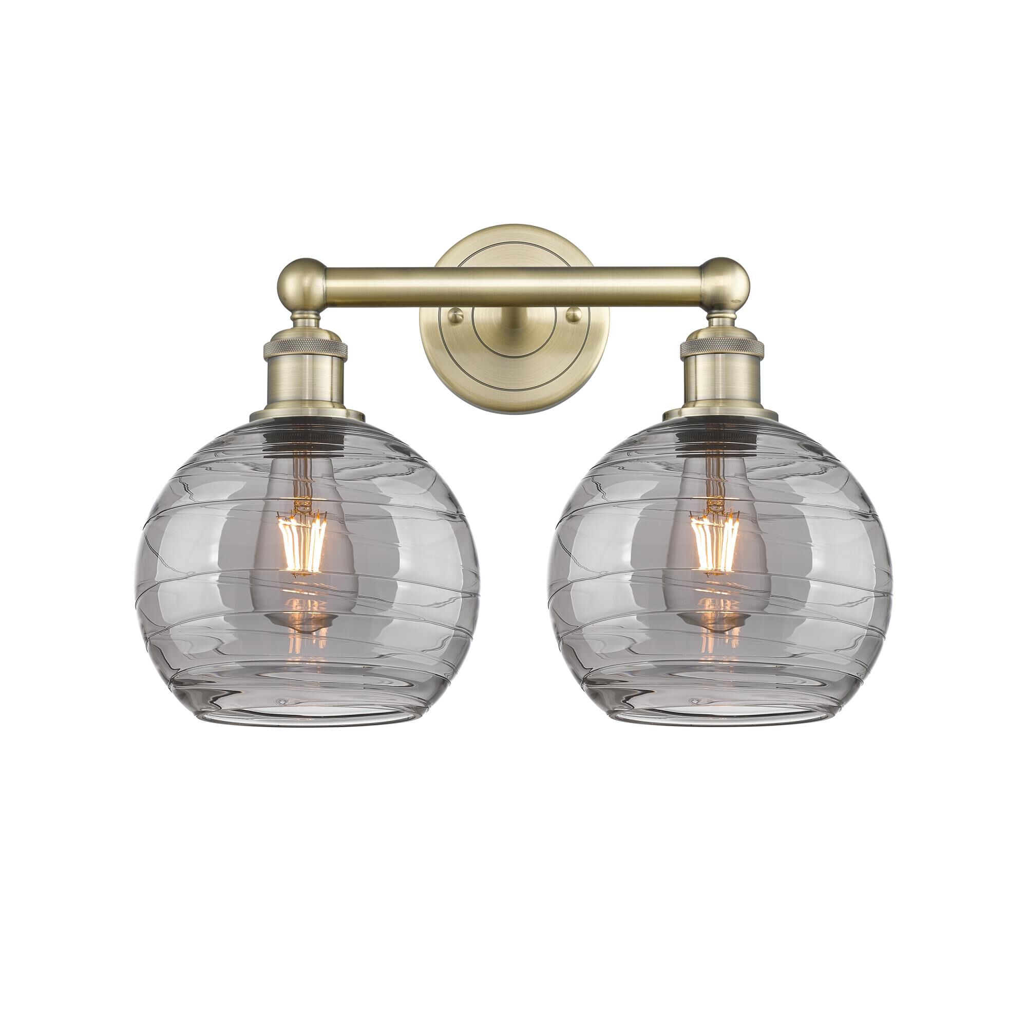 Shown in Antique Brass finish and Light Smoke Deco Swirl glass