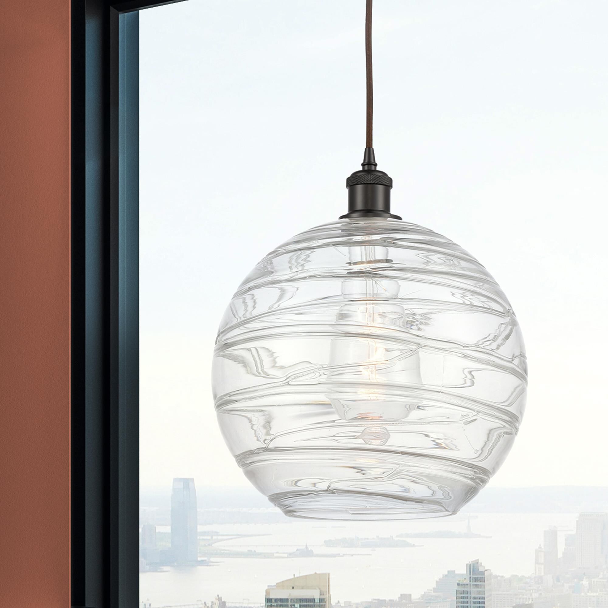 Shown in Oil Rubbed Bronze finish and Transparent Deco Swirl glass