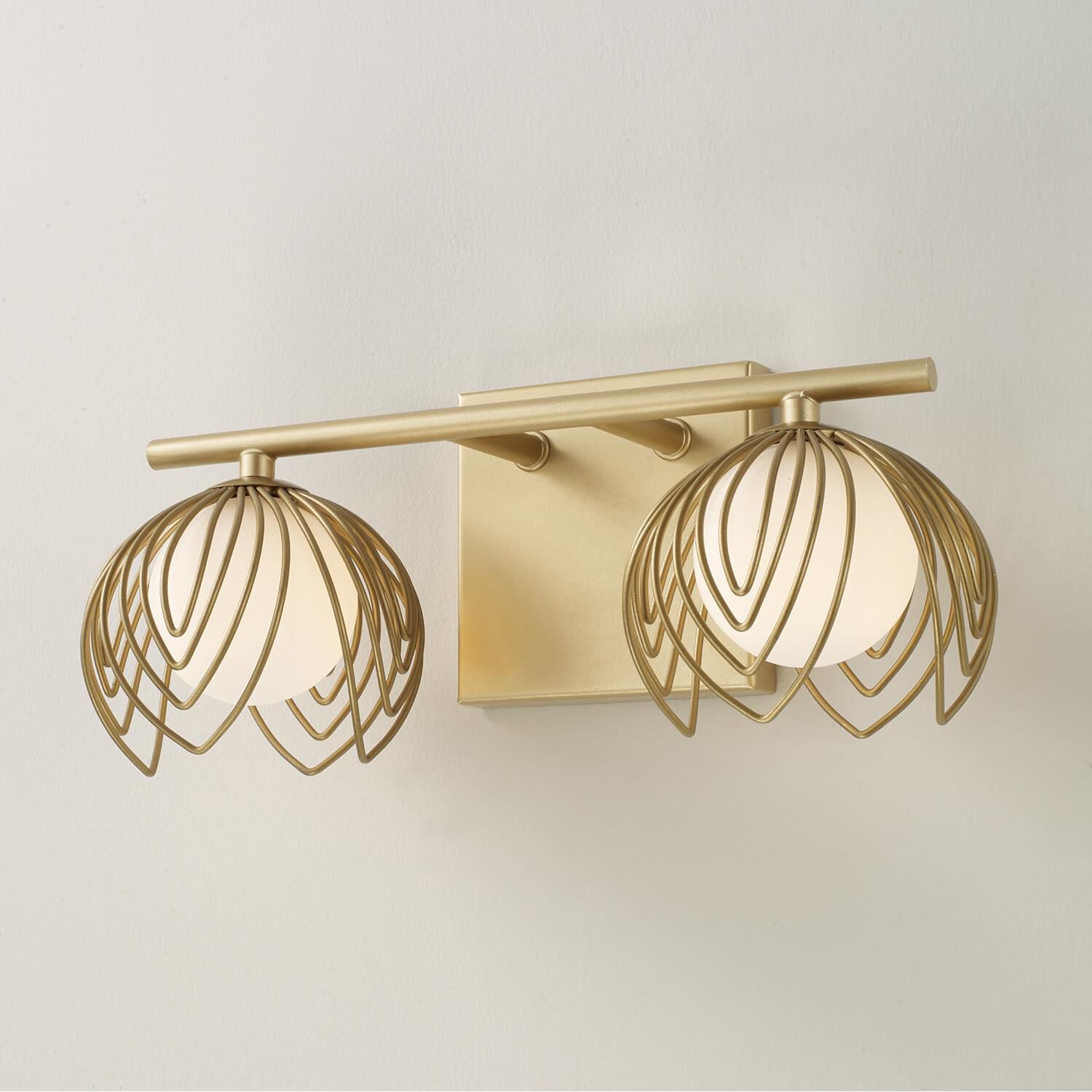 Shown in Buffed Gold finish and Soft White  Globes glass