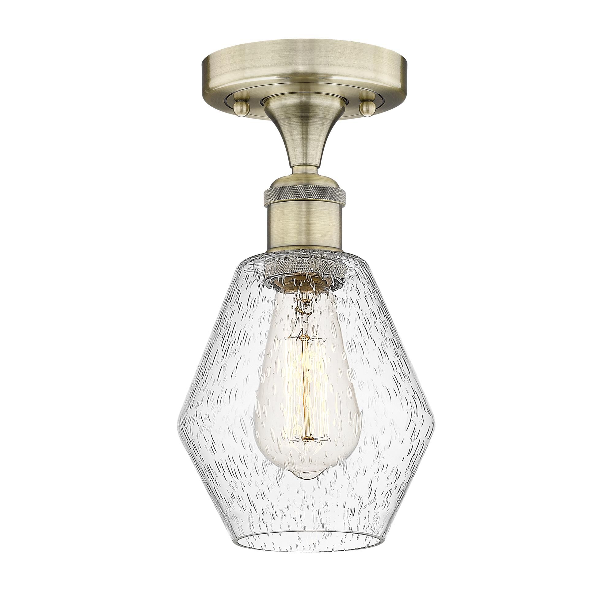 Shown in Antique Brass finish and Seedy glass