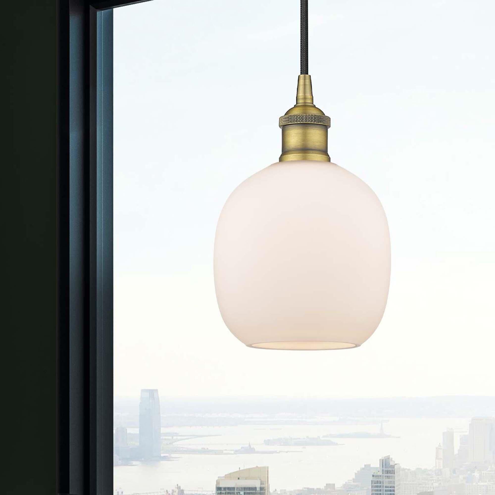 Shown in Brushed Brass finish and Matte White glass