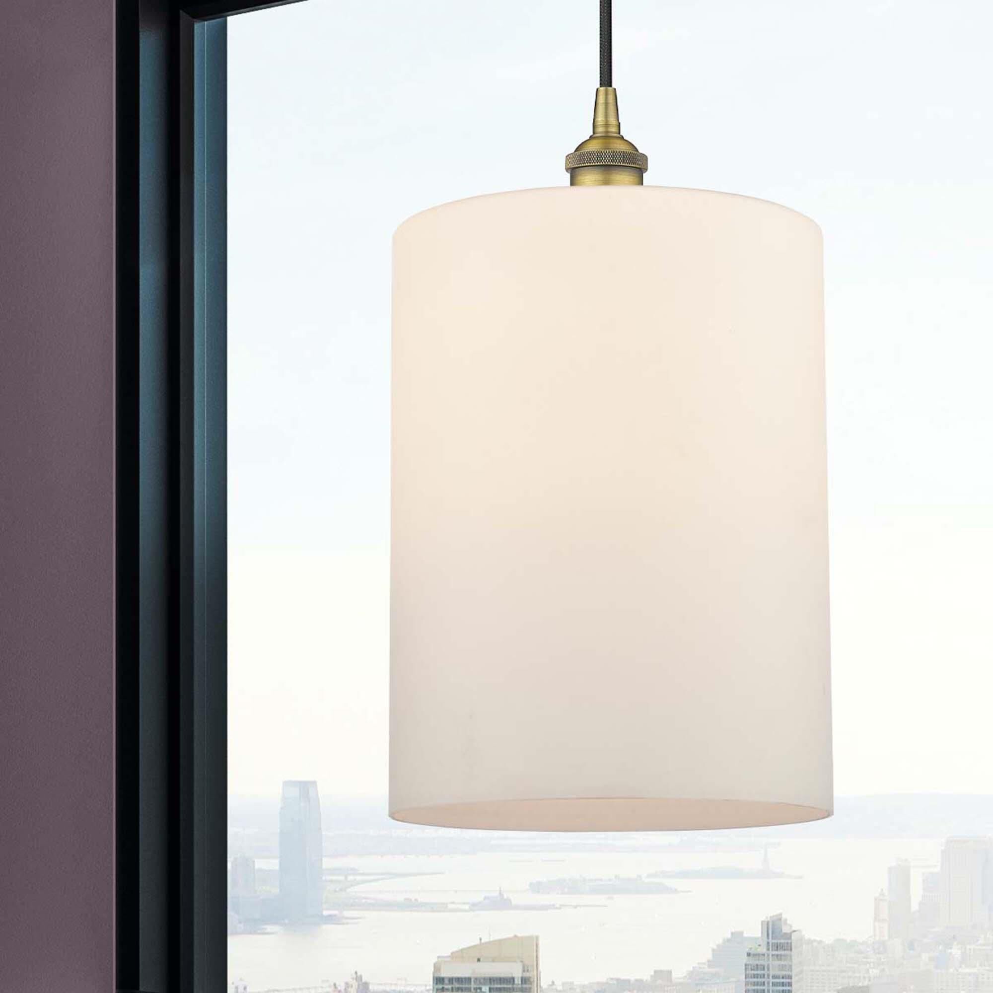 Shown in Brushed Brass finish and Matte White glass and Cord Hung accent