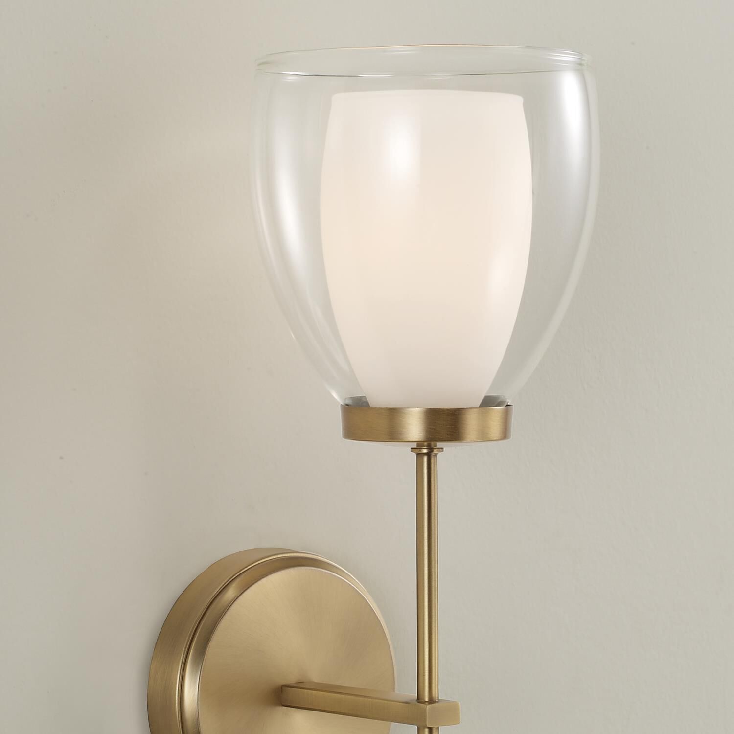 Shown in Aged Brass finish and Layered White And Clear glass