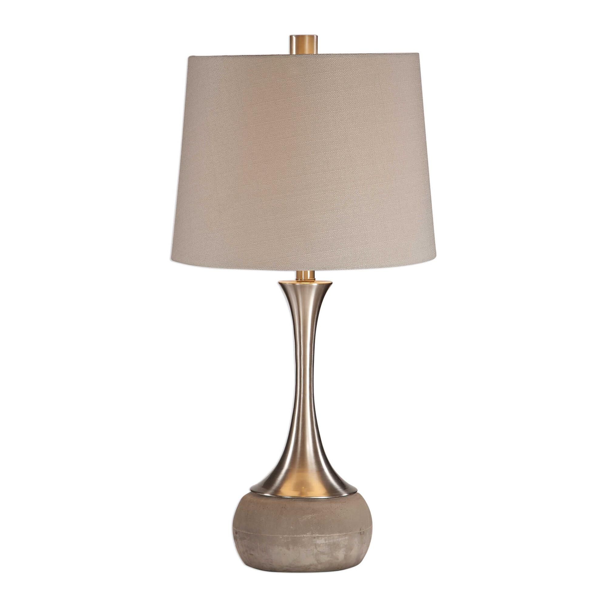 Shown in This Sleek Spun Metal Base Features A Plated Brushed Nickel Finish, Displayed On A Smoothed Natural  finish and Tapered Round Hardback shade