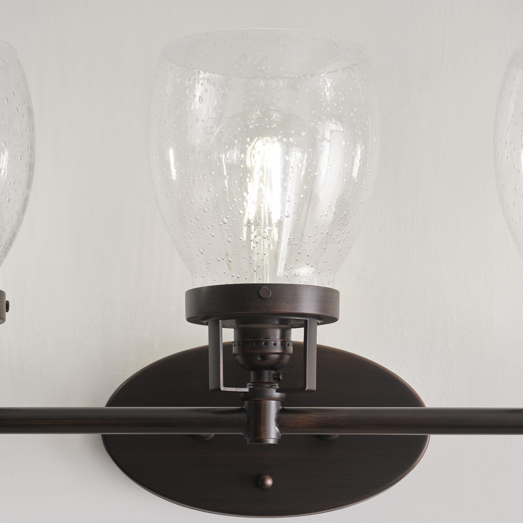 Shown in Bronze finish and Clear Seeded glass