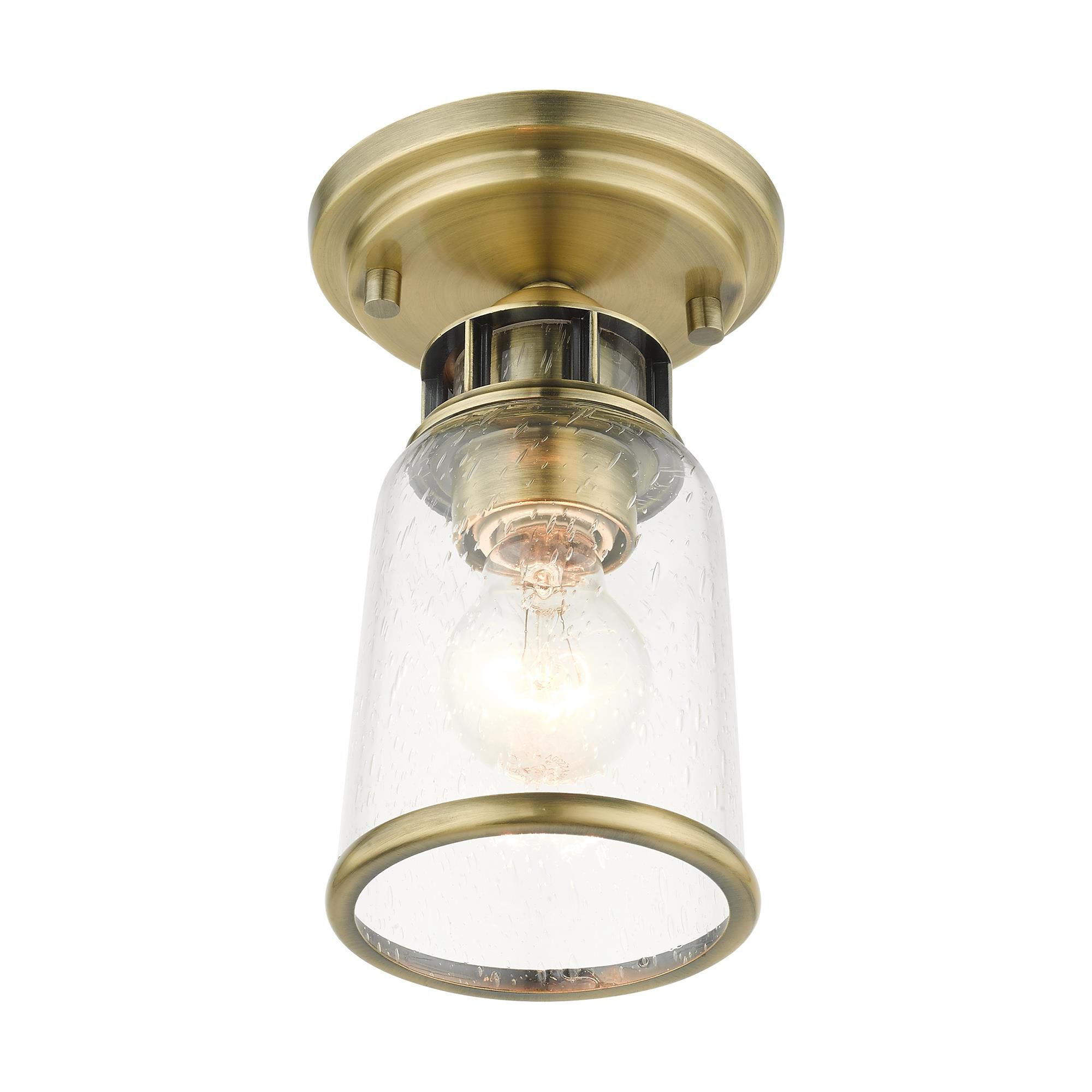 Shown in Antique Brass finish and Hand Blown Clear Seeded glass