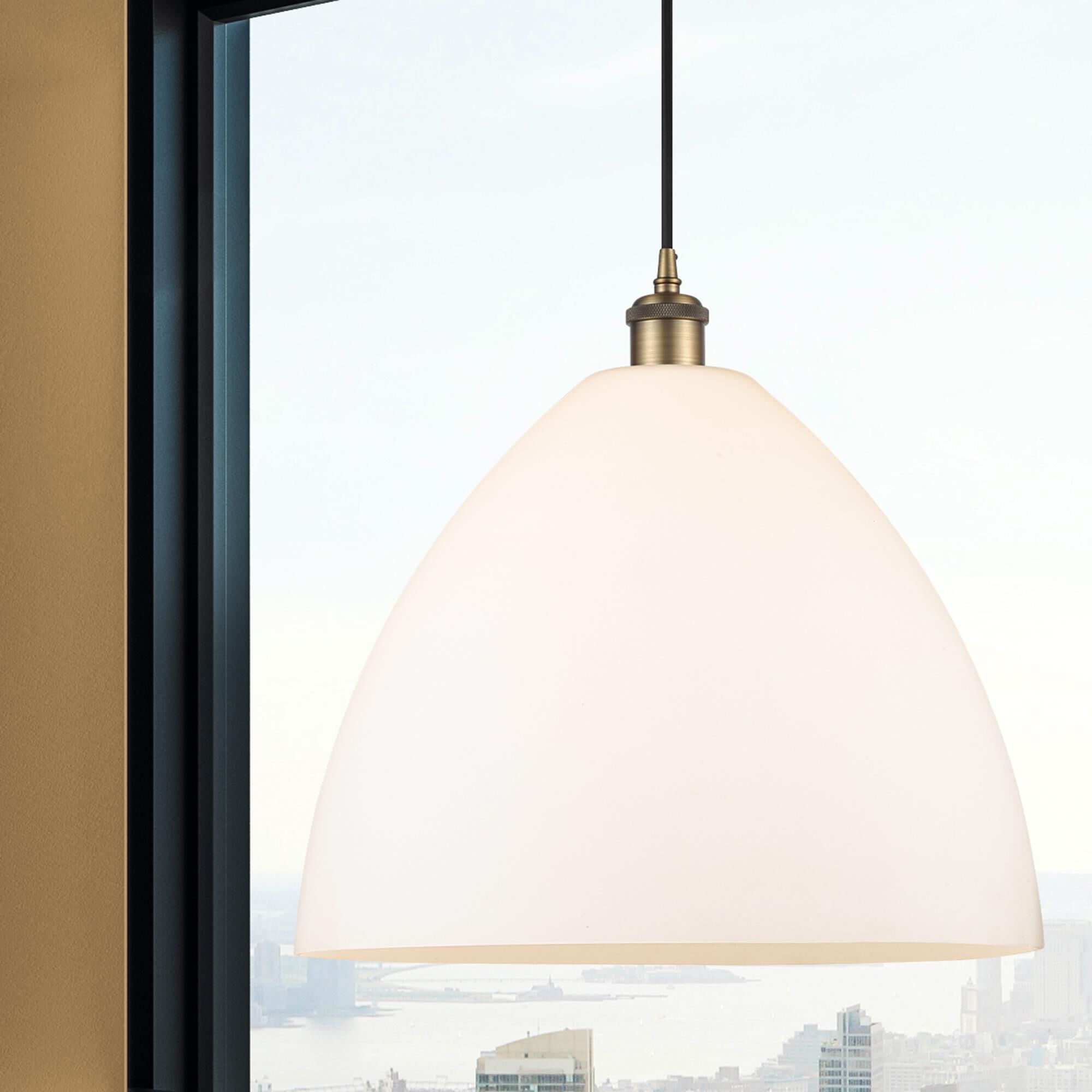 Shown in Brushed Brass finish and Matte White glass