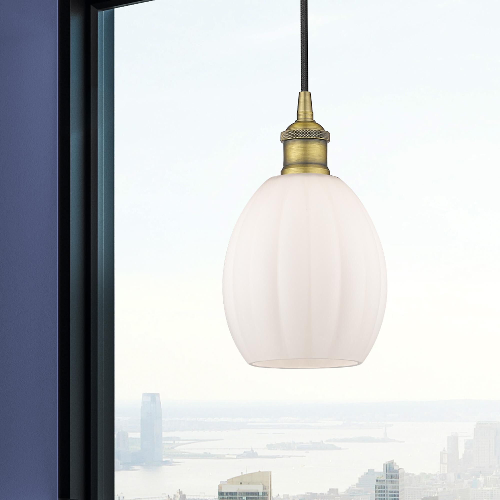 Shown in Brushed Brass finish and Matte White glass