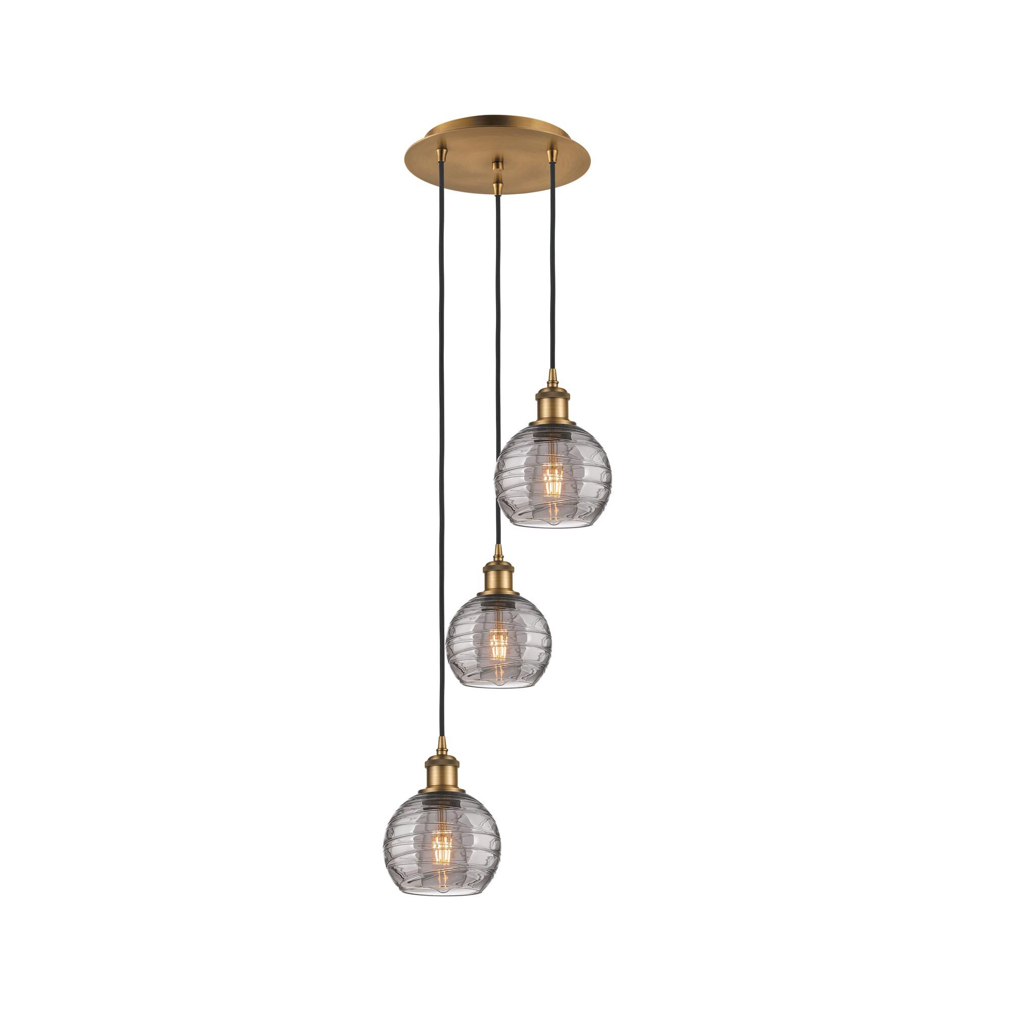 Shown in Brushed Brass finish and Light Smoke Deco Swirl glass