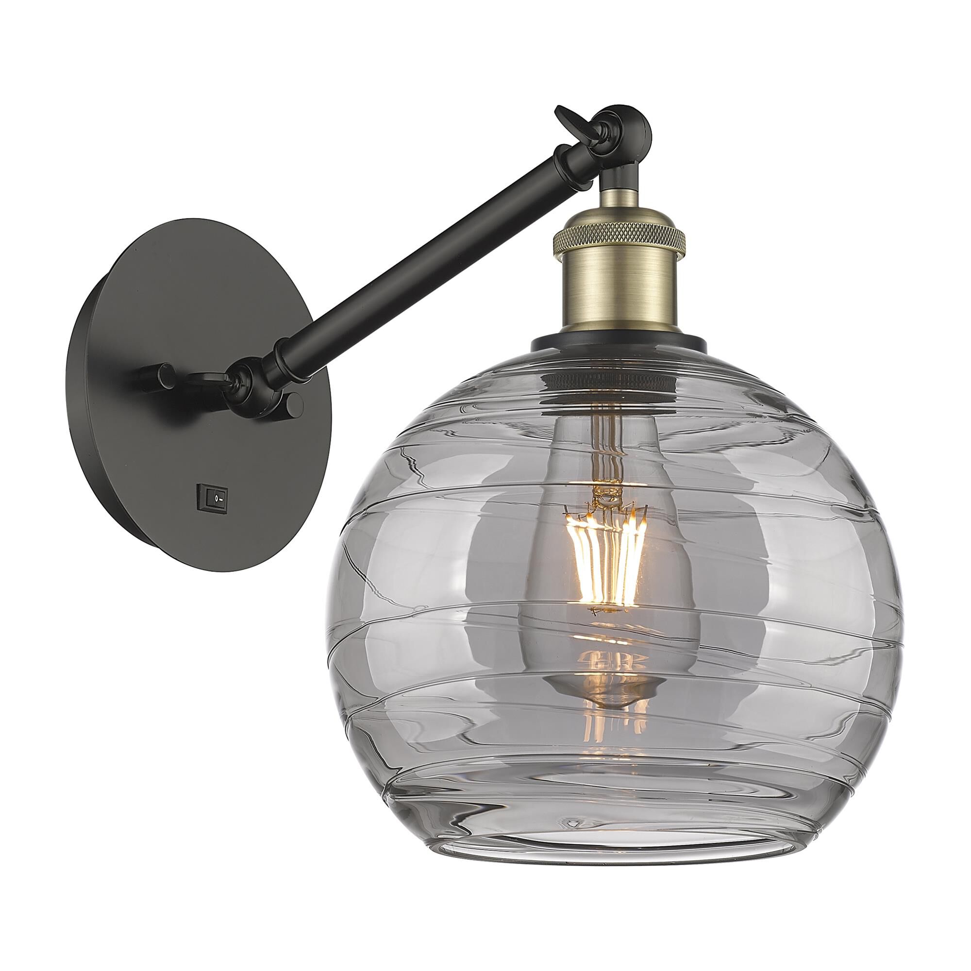 Shown in Black Antique Brass finish and Light Smoke Deco Swirl glass