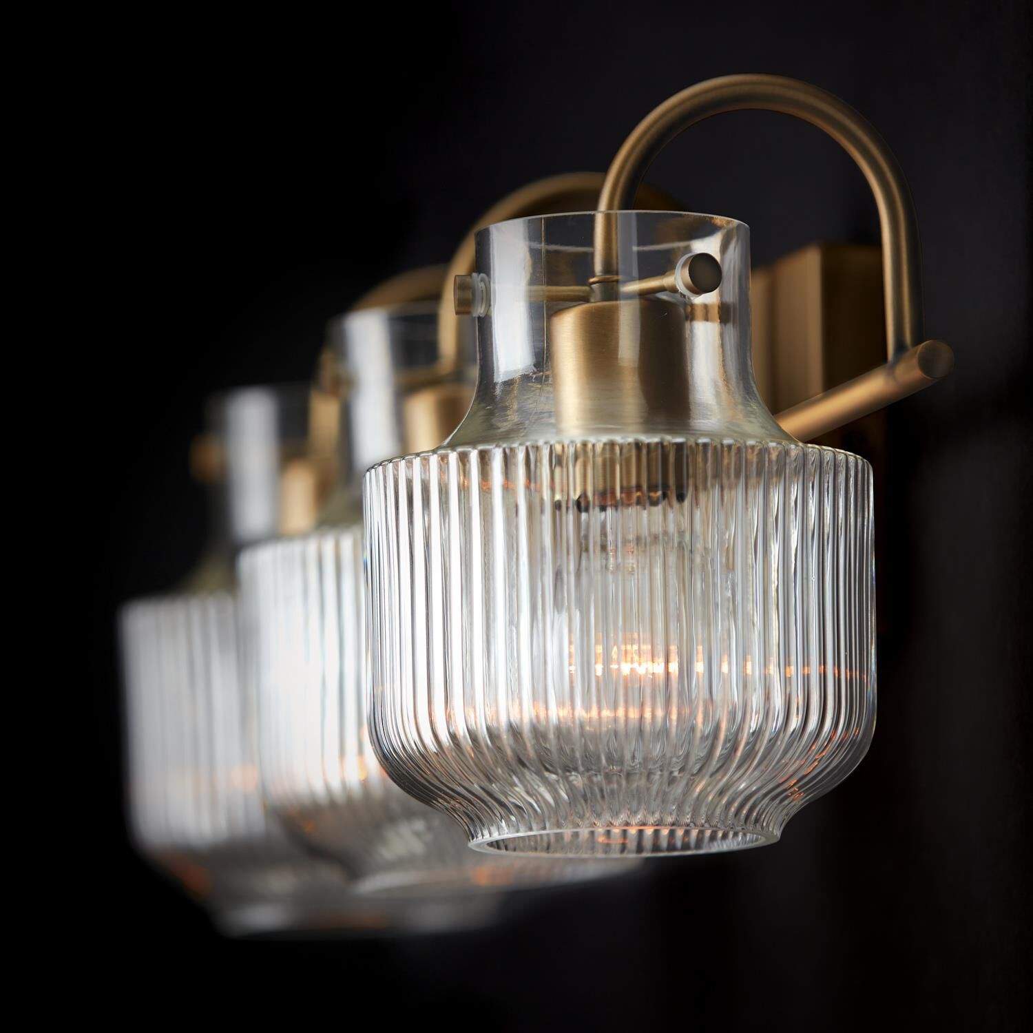 Shown in Aged Brass finish and Clear Fluted glass