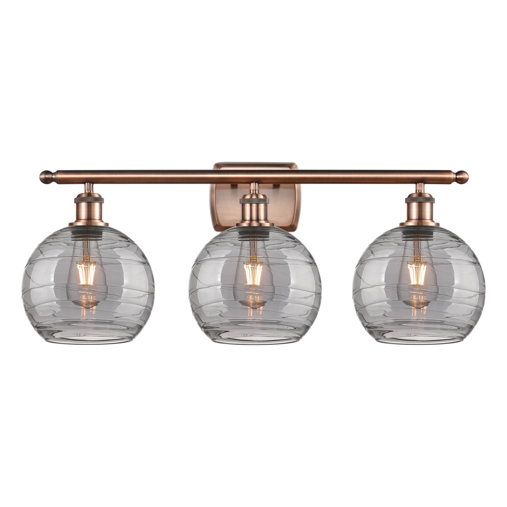 Shown in Antique Copper finish and Light Smoke Deco Swirl glass
