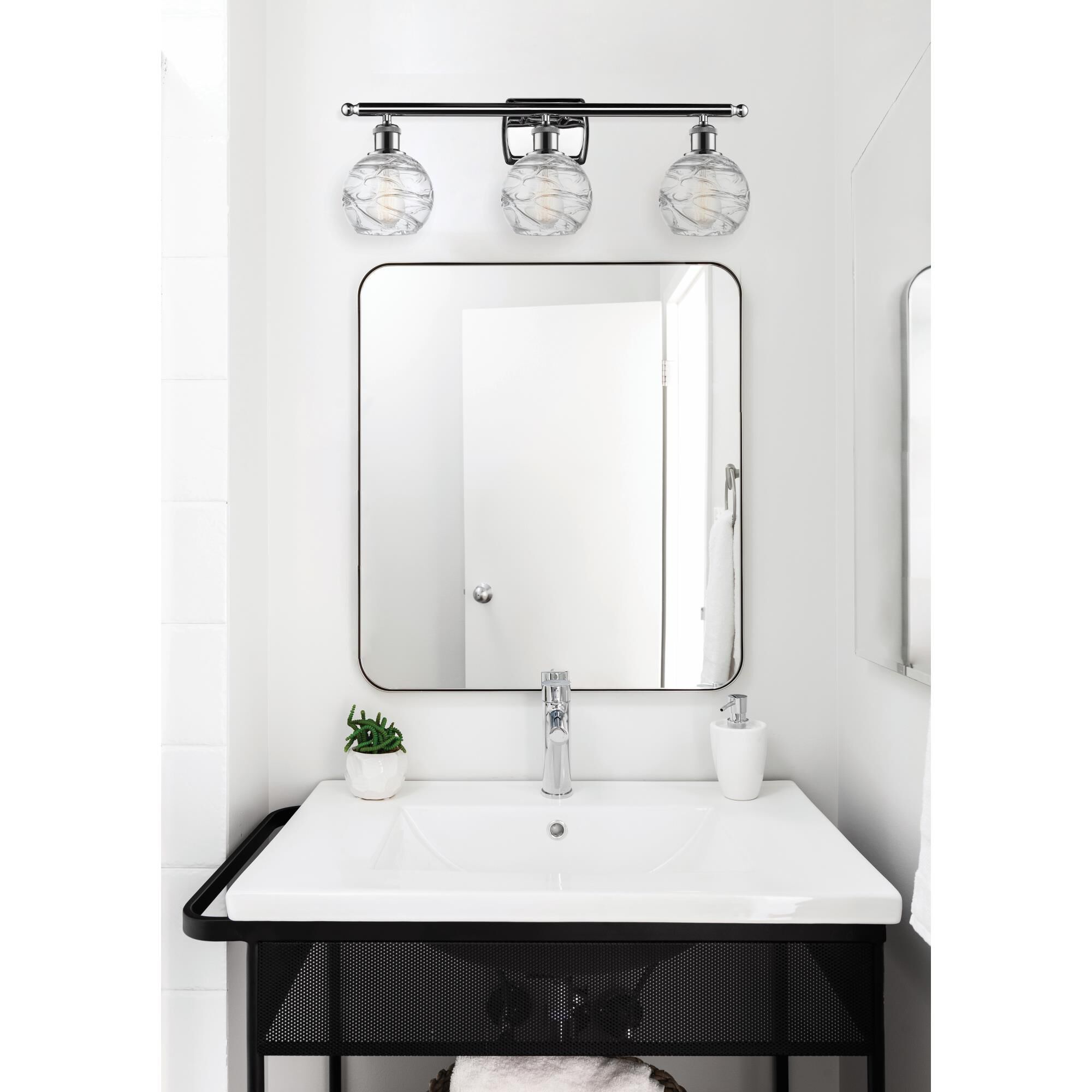 Shown in Polished Chrome finish and Clear Deco Swirl glass