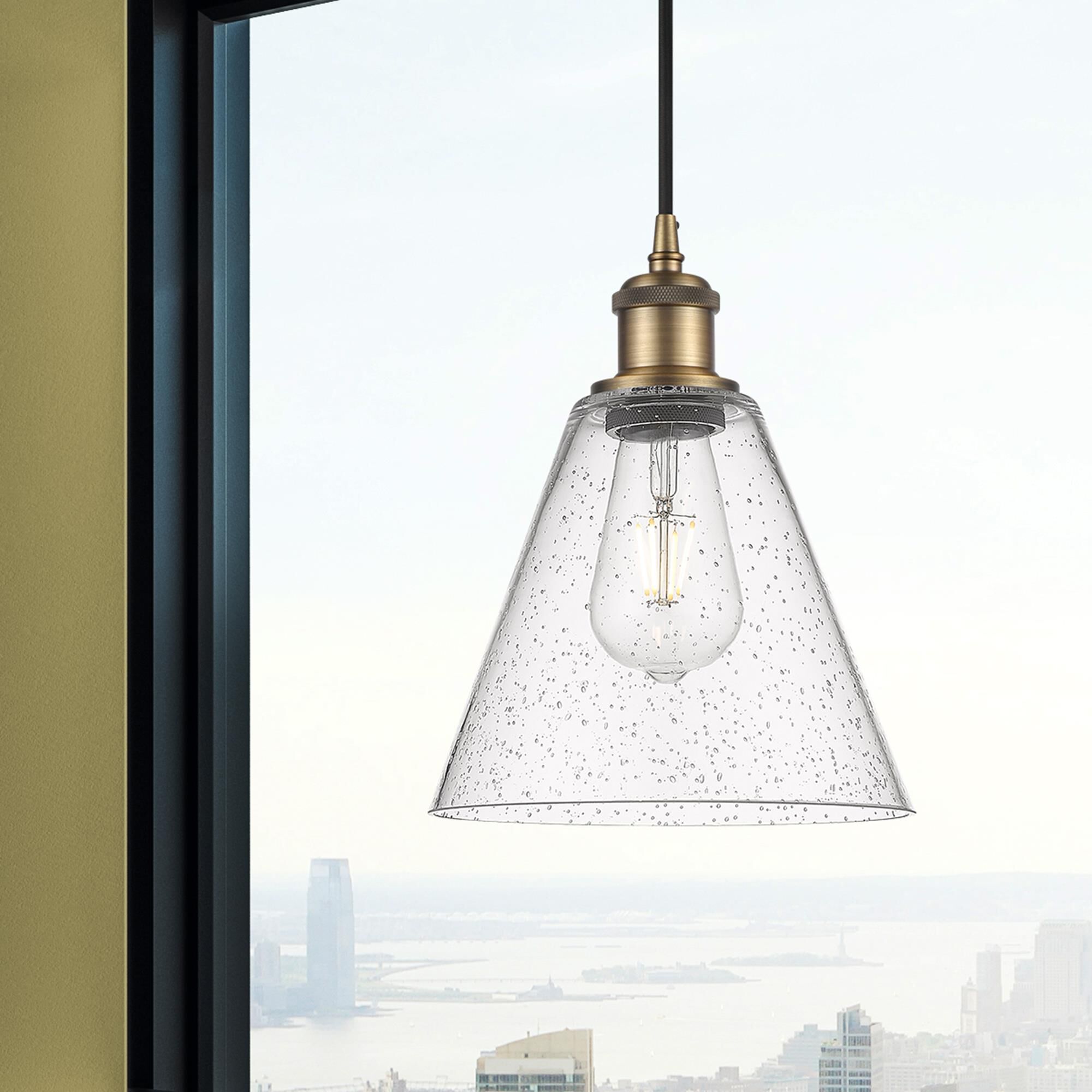 Shown in Brushed Brass finish and Seedy glass