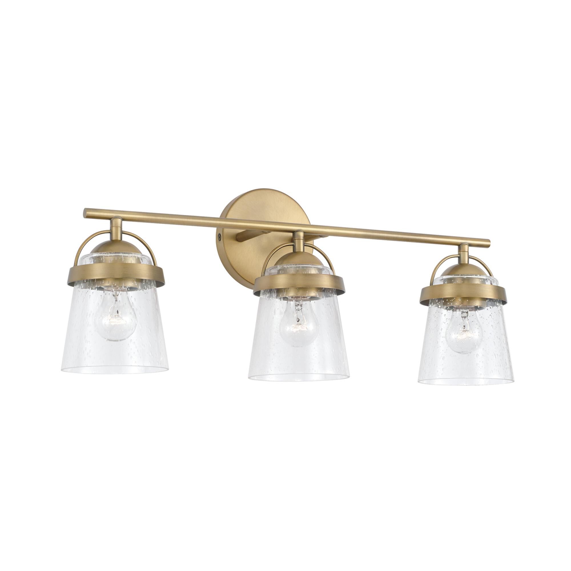 Shown in Aged Brass finish and Clear Seeded glass