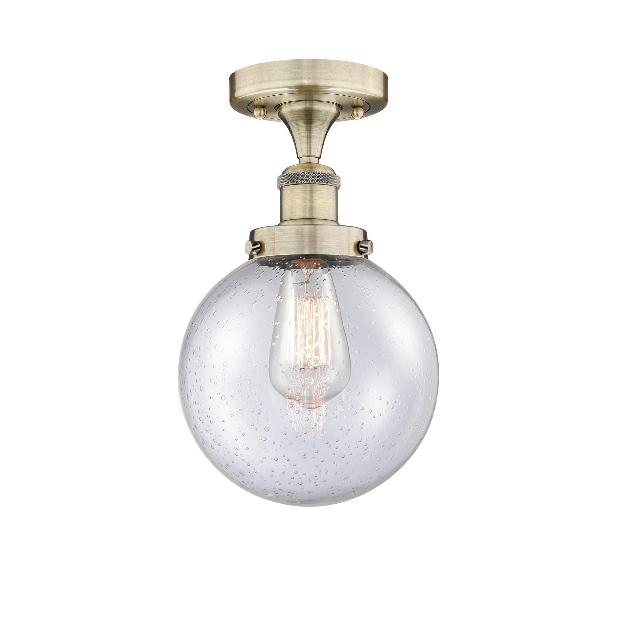 Shown in Antique Brass finish and Seedy glass