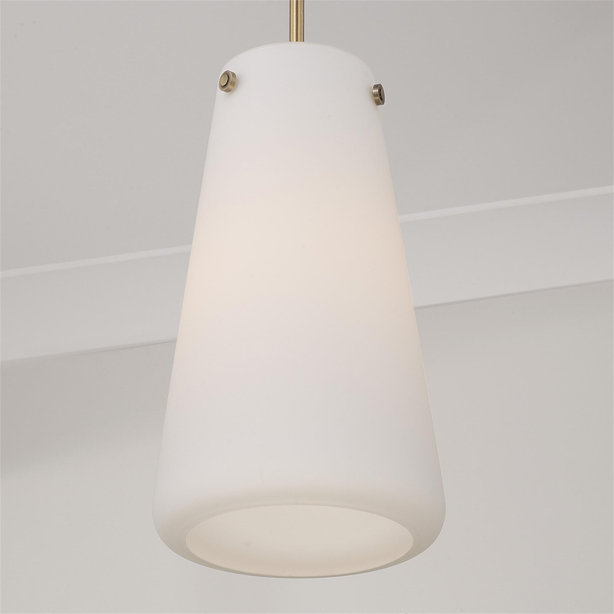 Shown in Aged Brass finish and Soft White glass