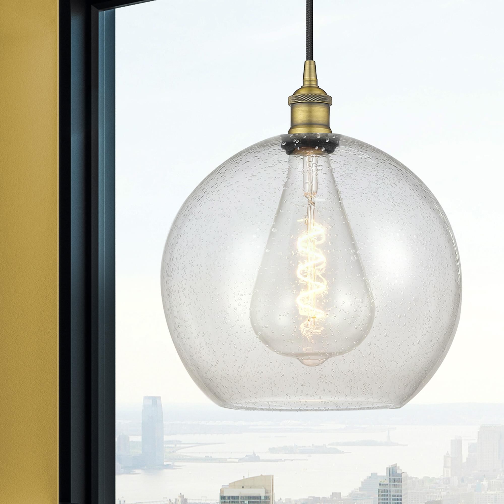 Shown in Brushed Brass finish and Seedy glass