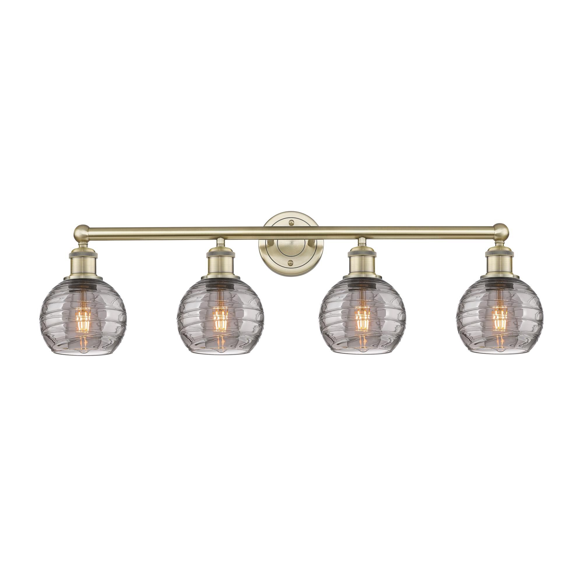 Shown in Antique Brass finish and Light Smoke Deco Swirl glass