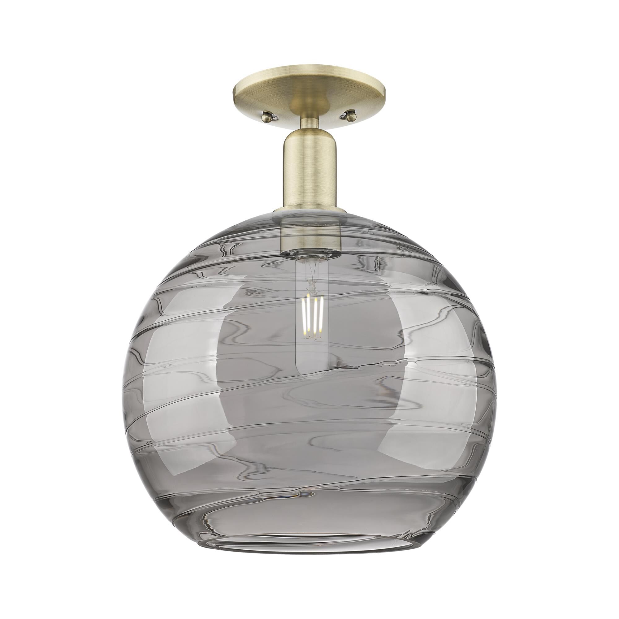 Shown in Antique Brass finish and Light Smoke Deco Swirl glass