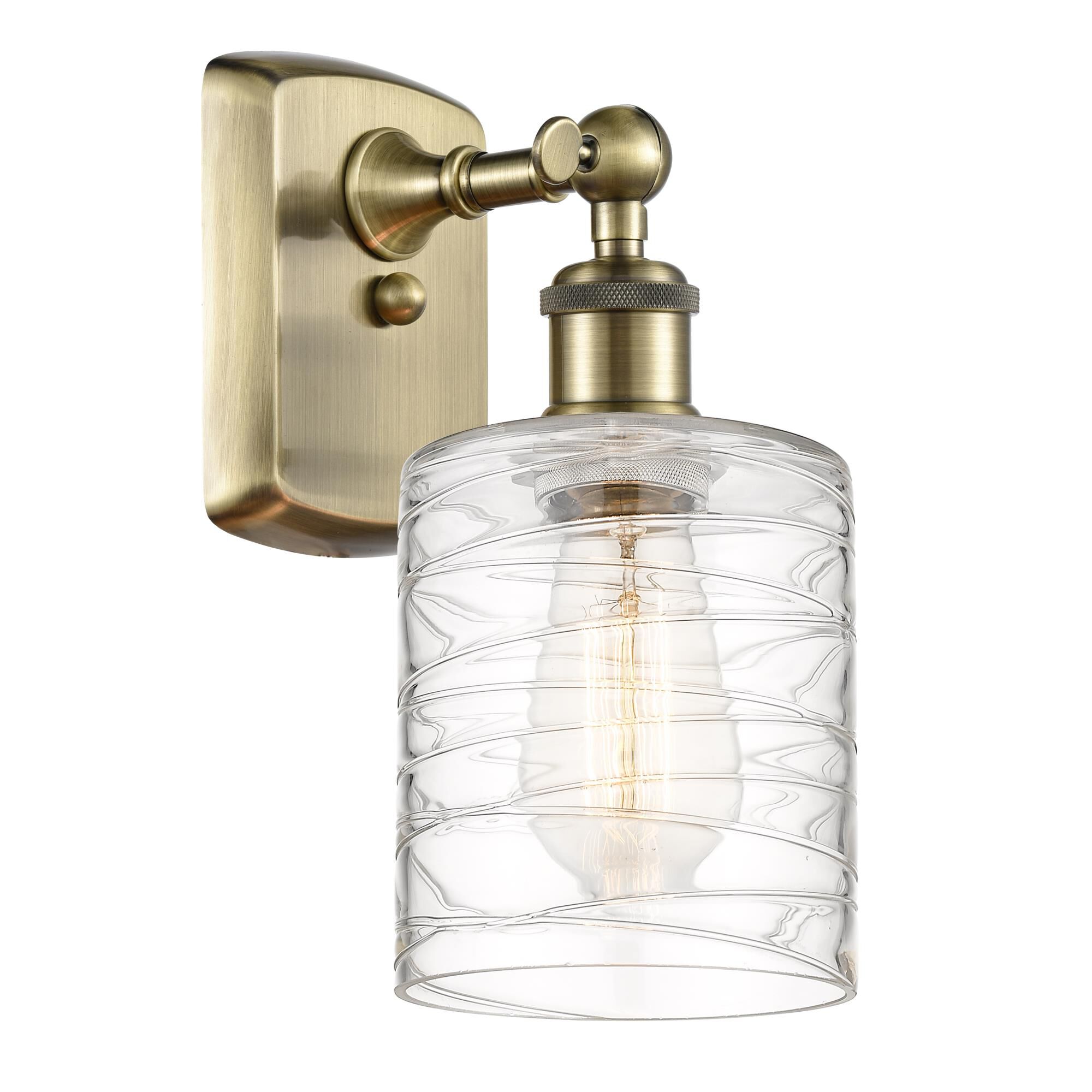Shown in Antique Brass finish and Deco Swirl Cobbleskill glass
