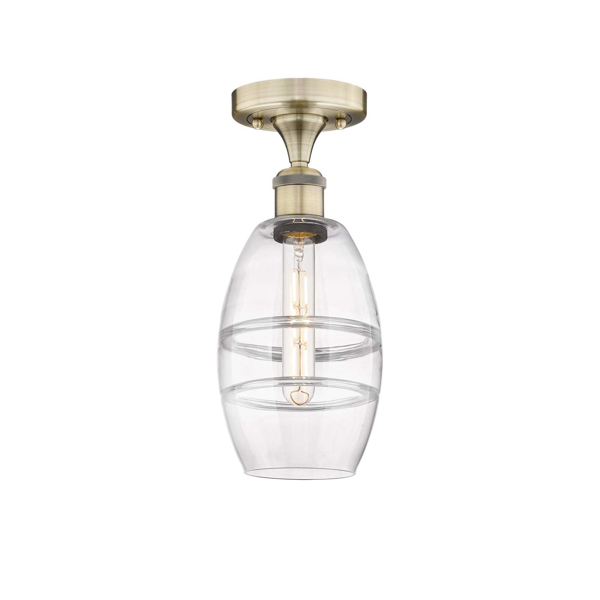 Shown in Antique Brass finish and Clear glass