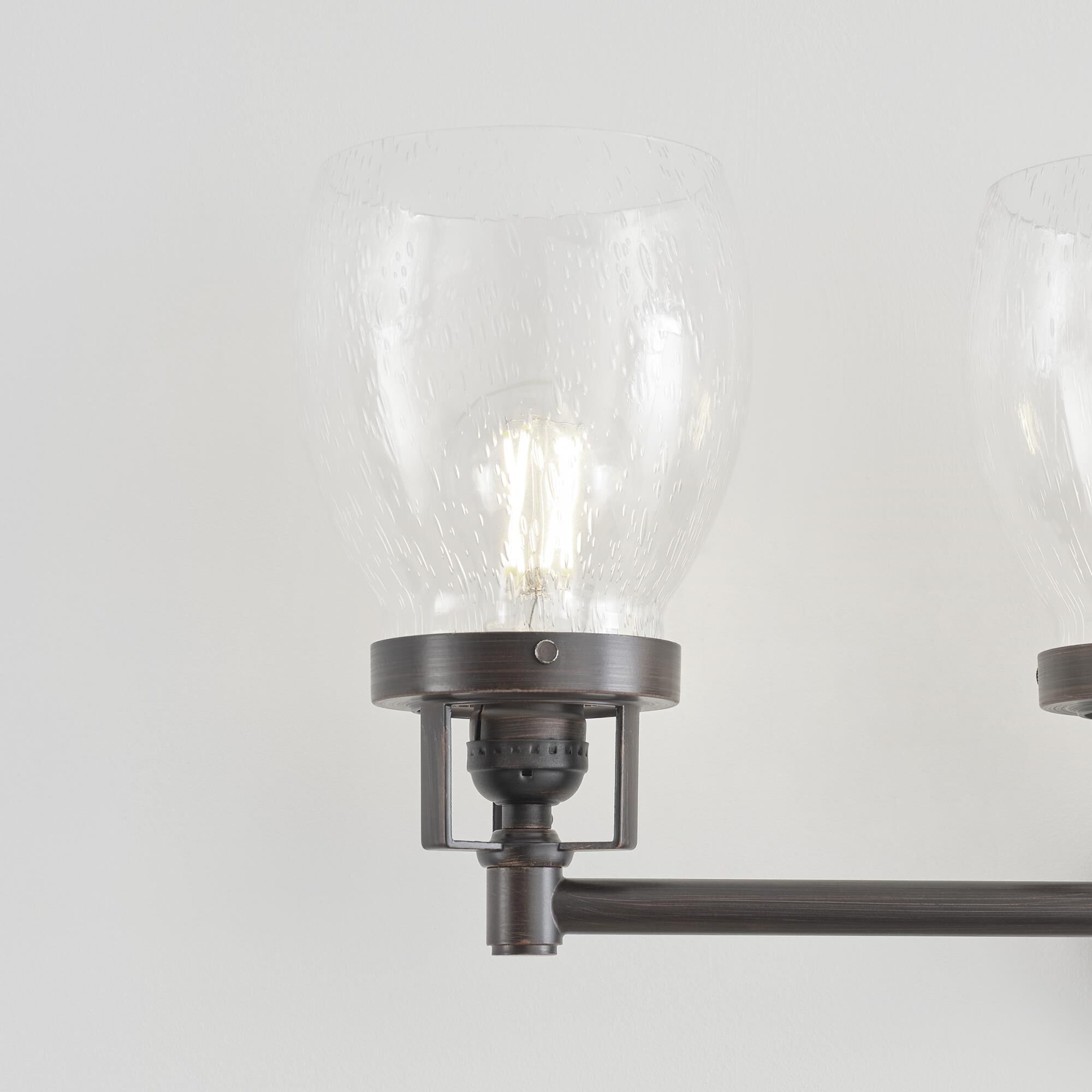 Shown in Bronze finish and Clear Seeded glass