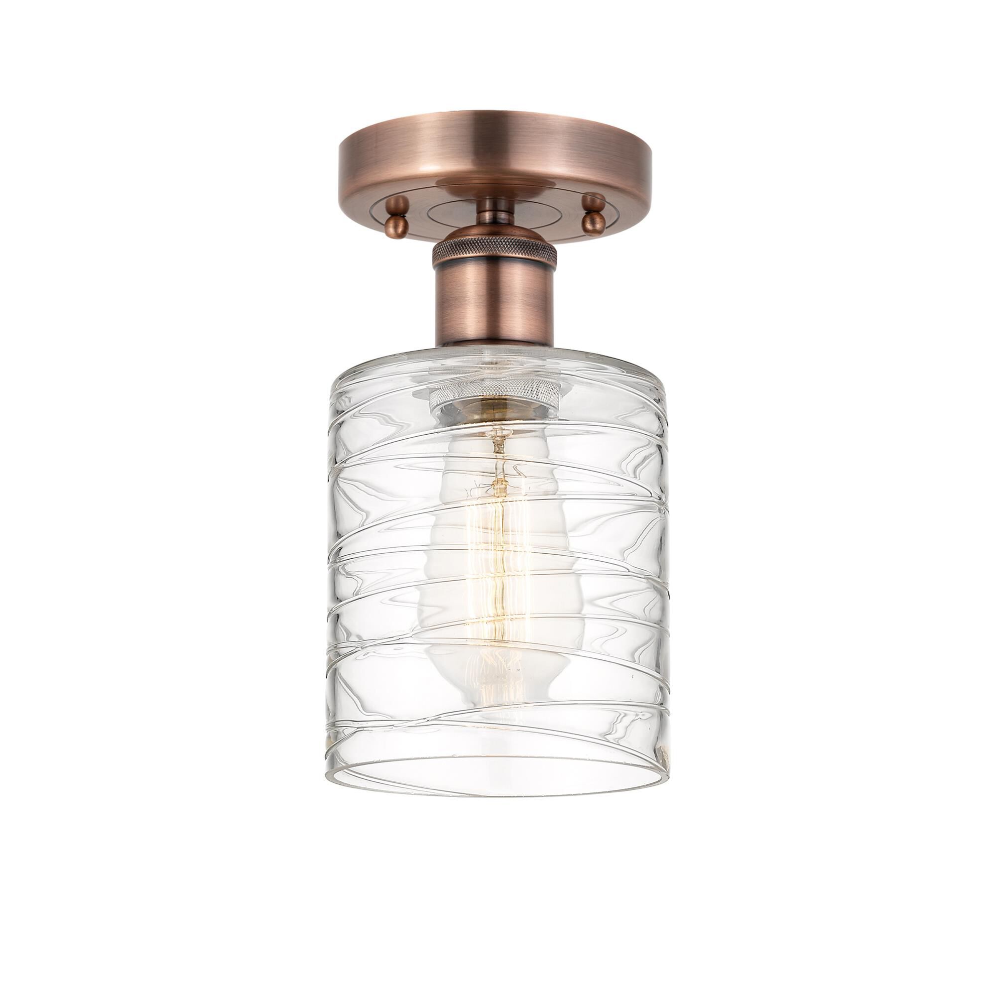 Shown in Antique Copper finish and Deco Swirl glass