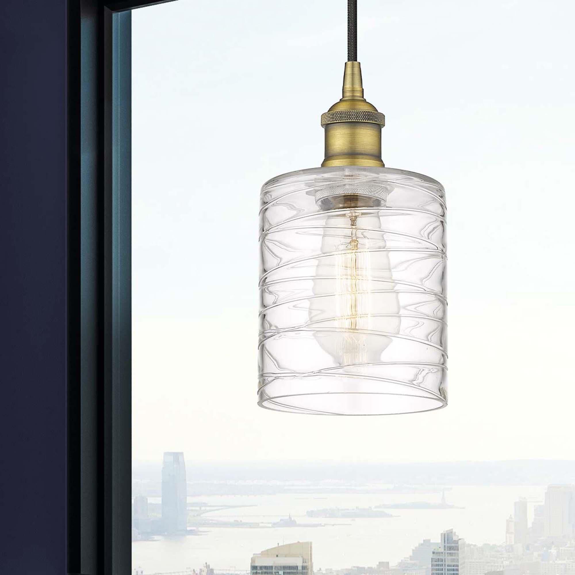 Shown in Brushed Brass finish and Deco Swirl glass